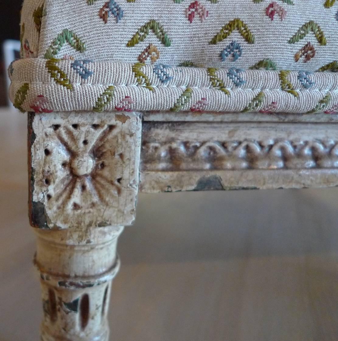 French 19th century four-leg foot stool newly re-upholstered with vintage fabric.
