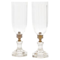 A set of six brass and hurricane glass lamps
