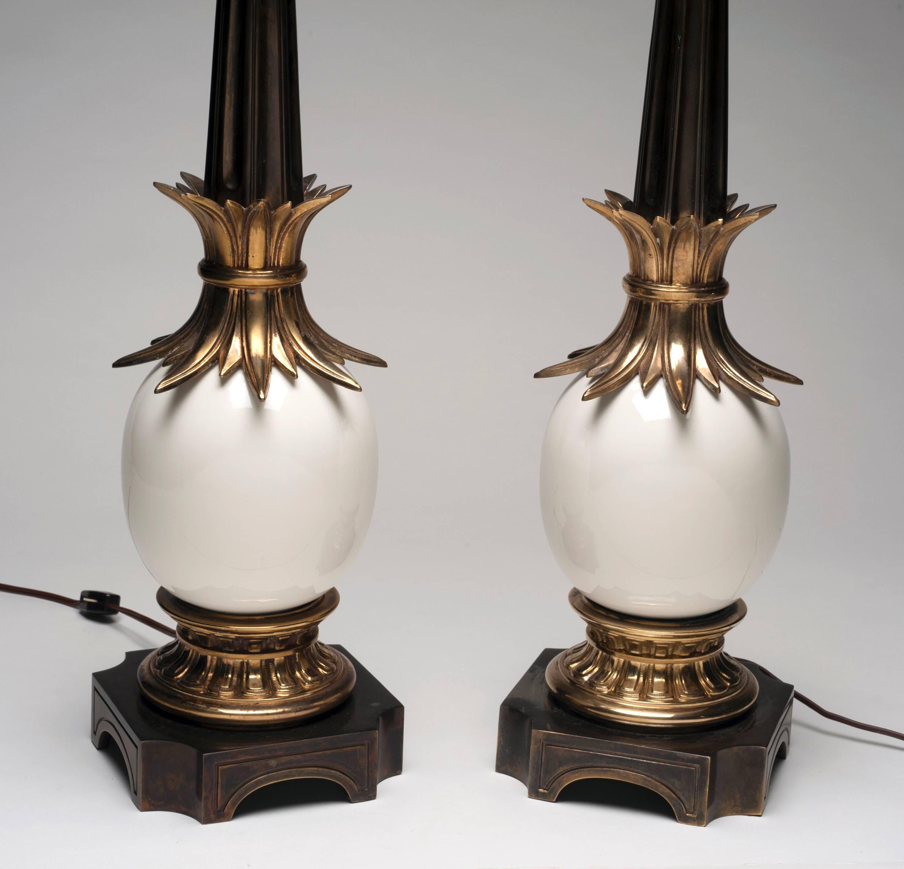 Striking pair of Ostrich egg lamps by Stiffel. Well constructed lamps are made with brass and porcelain and come complete with shades and solid brass finial. Condition is excellent.