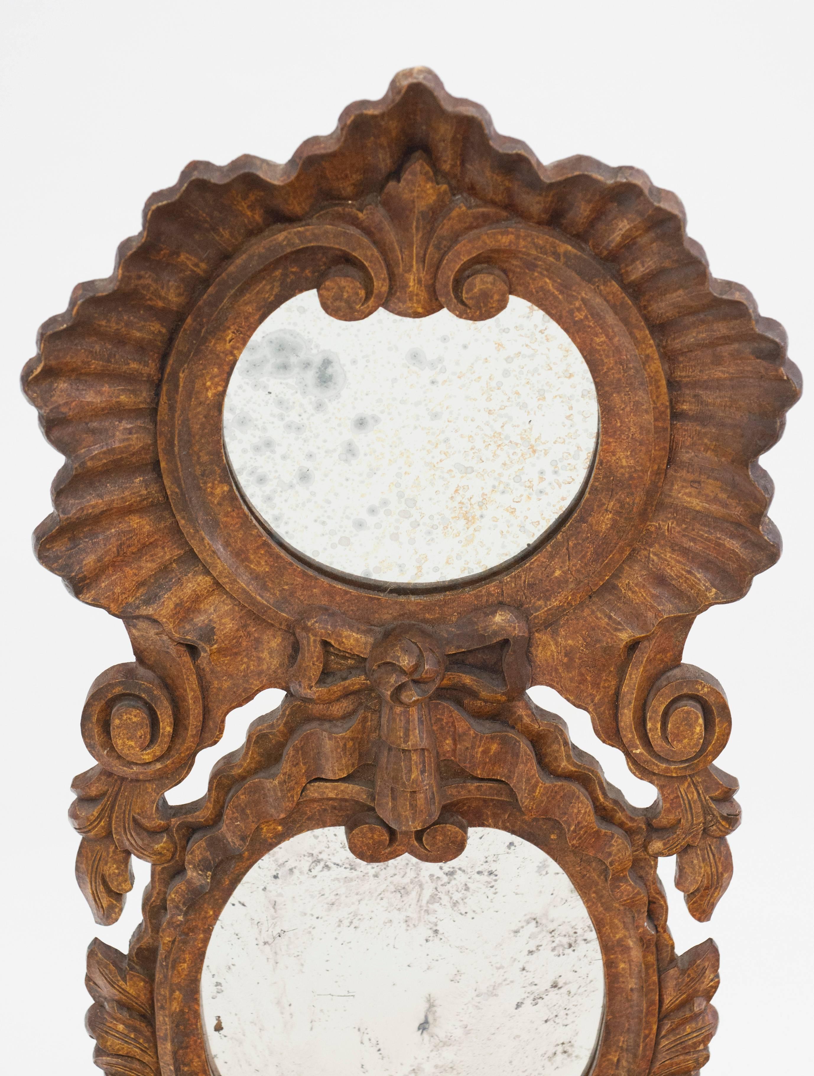 Beautiful hand-carved decorative speckled mirror by Chapman. Carved double mirror has built in planter on bottom and is in excellent condition. Measures: 48 inches H x 17.5 W.