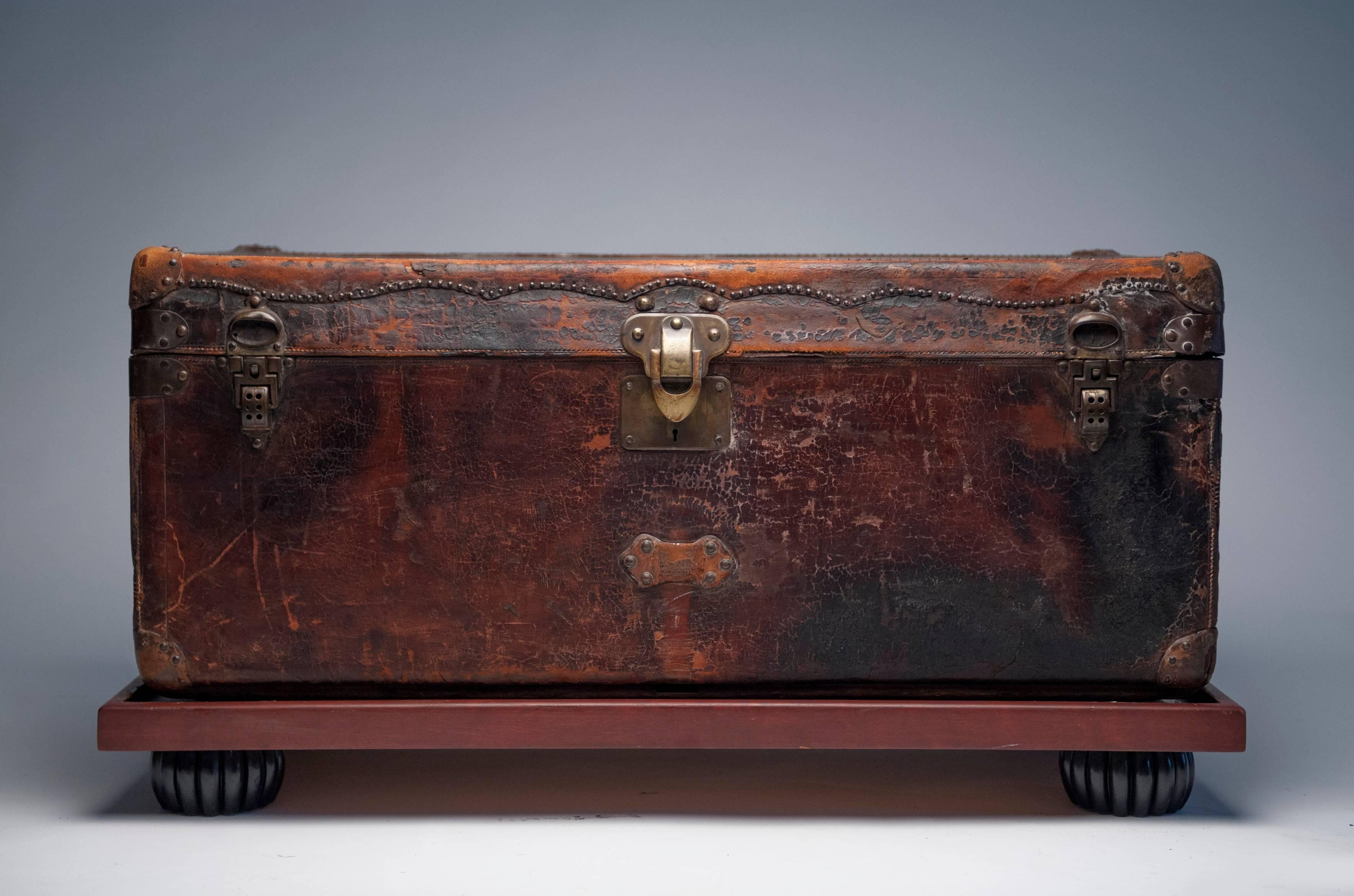 Appealing unrestored antique Louis Vuitton leather steamer trunk. Unusual brass latches and button design details. Retains original orange suede interior. Three brass latches work normally.  Custom wood base for display will be included.