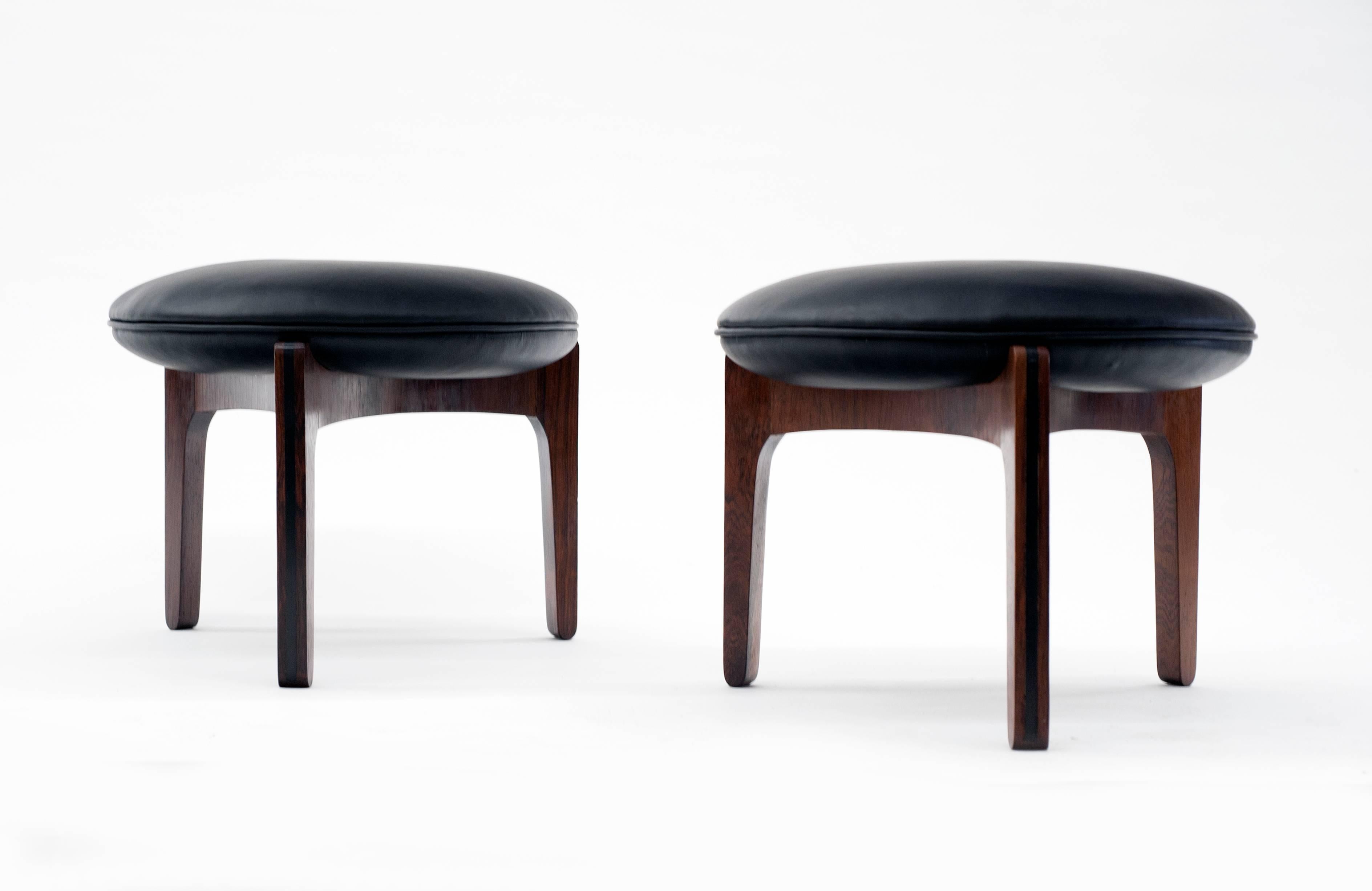 Appealing pair of stools by Danish designer Sven Ellekaer. Stools are quality made of Brazilian rosewood with ebony details. They have been professionally reupholstered in soft Italian leather. Condition is excellent.