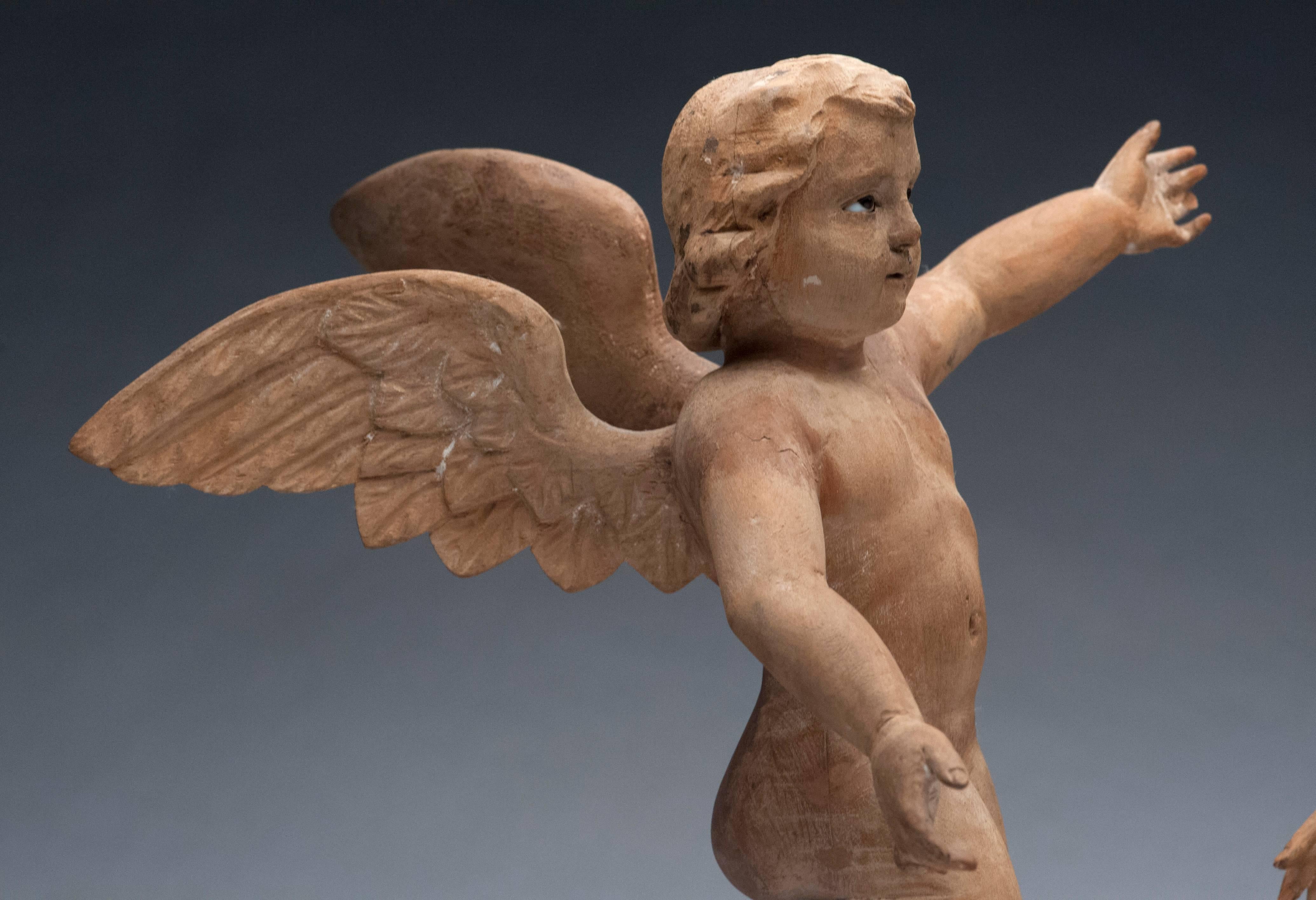 Beautifully carved pair of winged Cherub's with inset glass eyes from the 18th century.