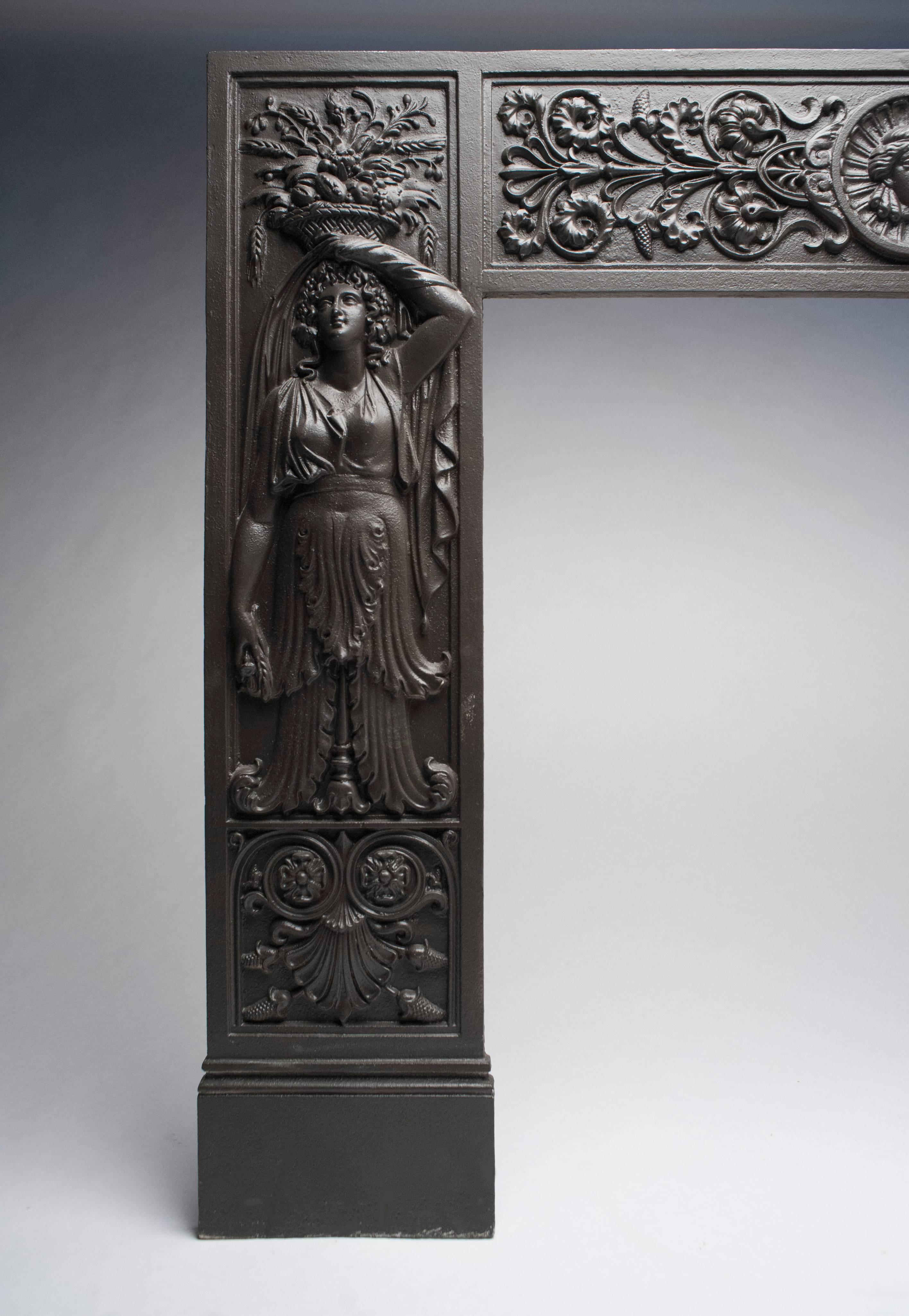Antique Victorian cast iron fireplace surround. Ornate details with two Classic woman figures. Measures 42 inches W x 35 H. Interior measures 26 W x 27.75 H.
