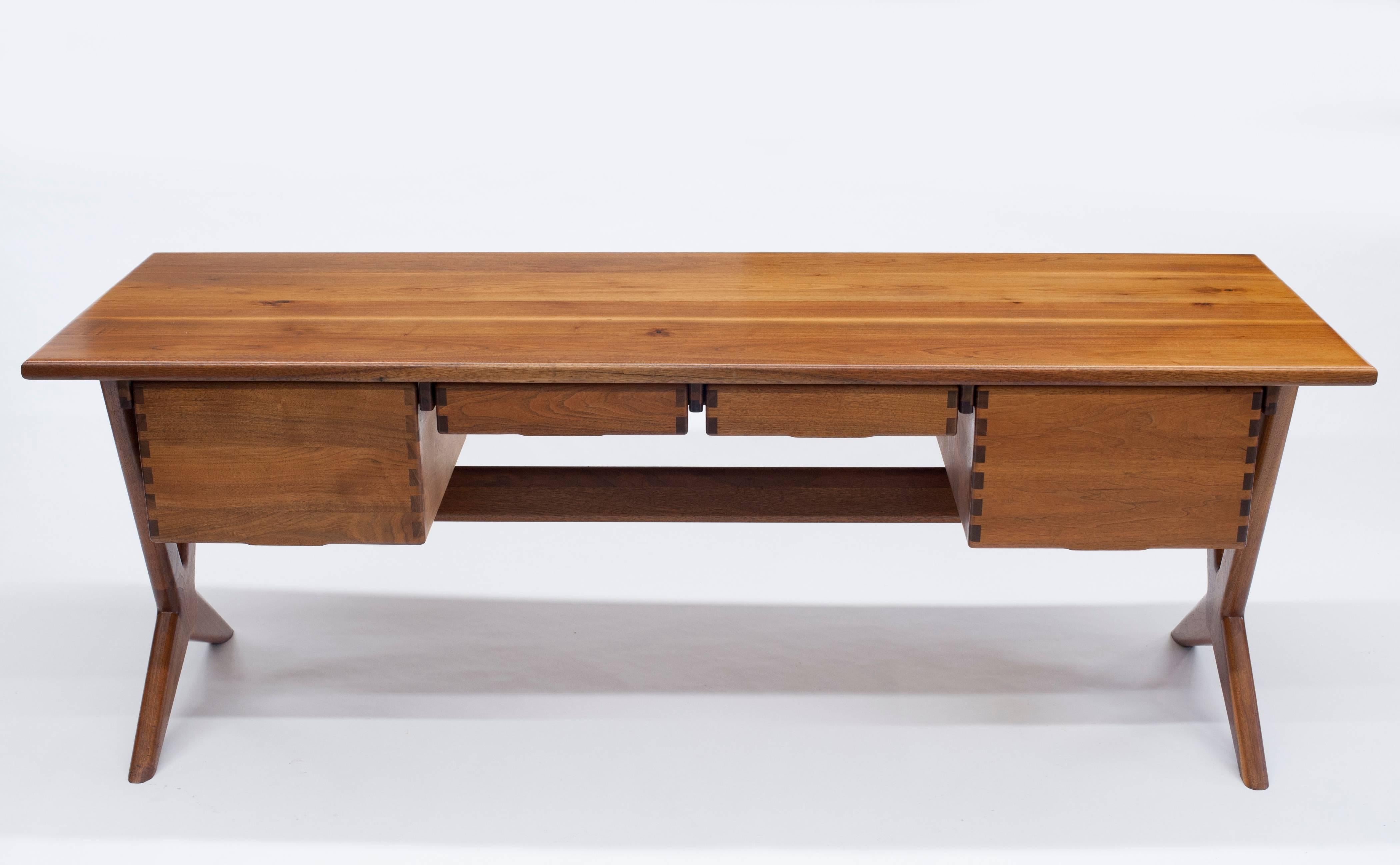 1970s custom desk for the Esprit offices in San Francisco by MIT graduate and California master craftsman Jim Sweeney. Constructed with solid walnut top, drawers, trestle and angled legs. Designed with beautiful and bold joinery. This is the largest