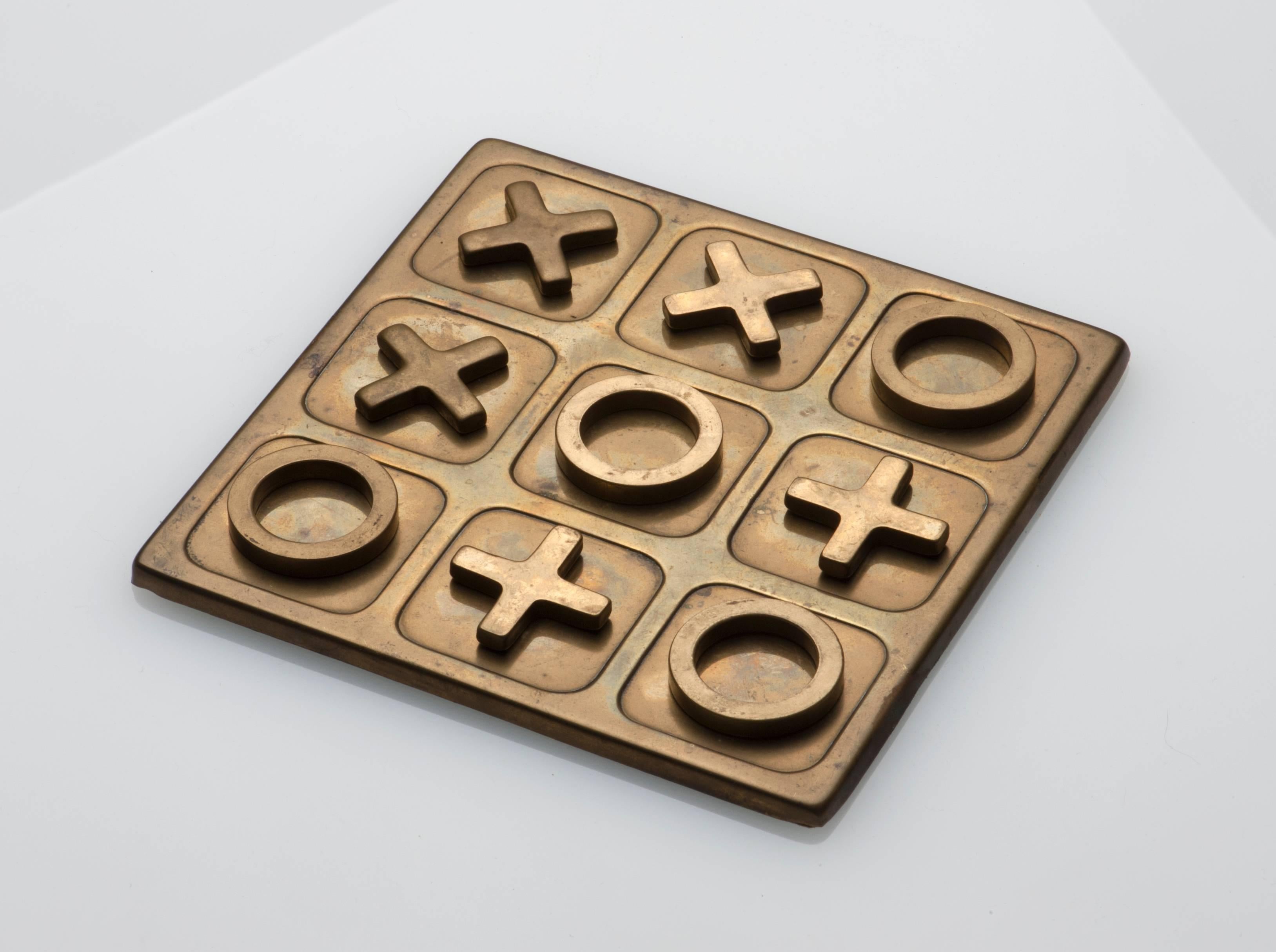 Appealing vintage brass game of Tic Tac Toe. Complete with ten pieces. Green felt to underside.