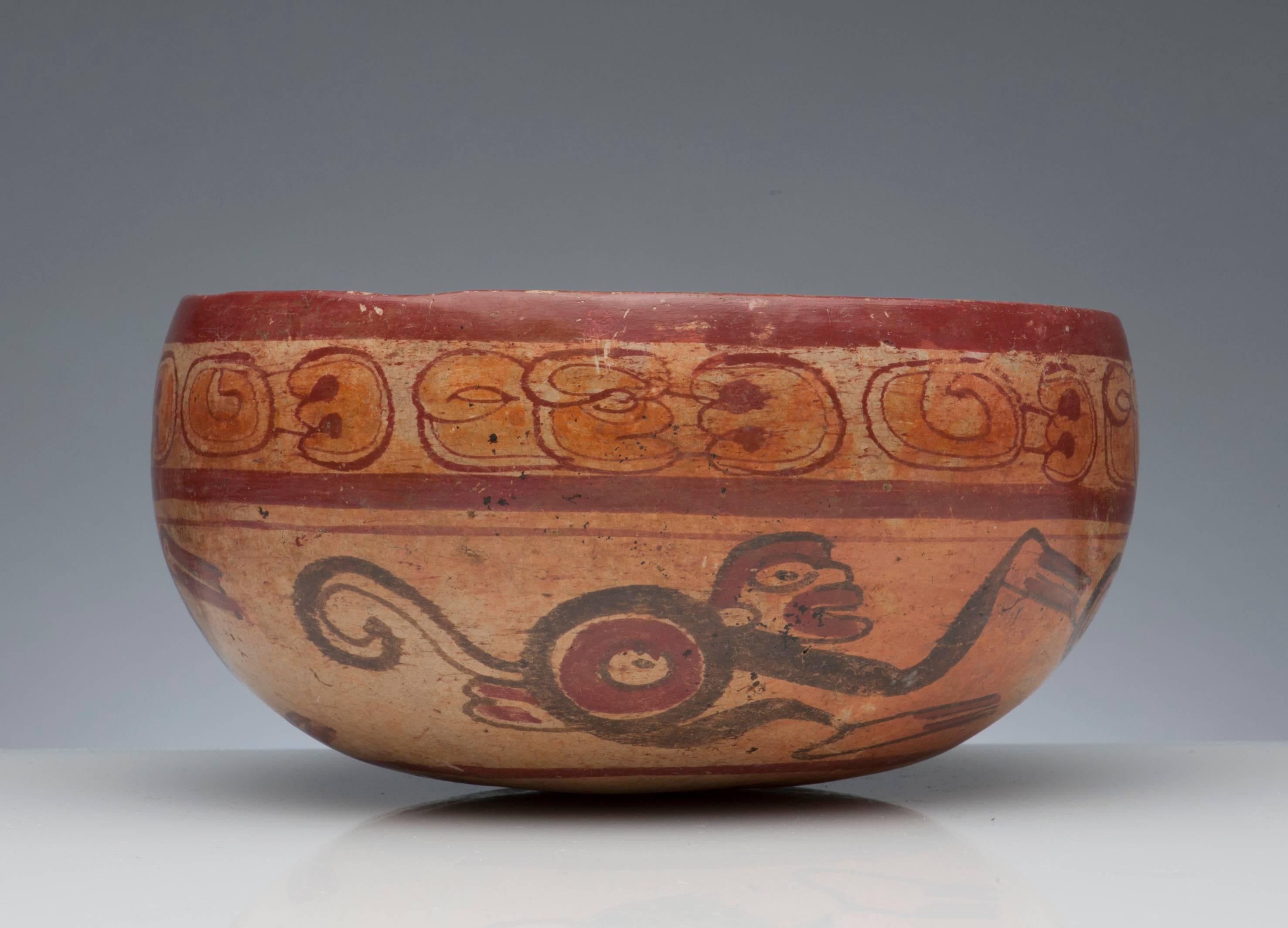 A fine Pre-Columbian Maya bowl, circa 600-900 A.D. Decorated with nicely detailed monkey's and painted glyphs. Measures 7.5 inches in diameter and 3.75 inches high.