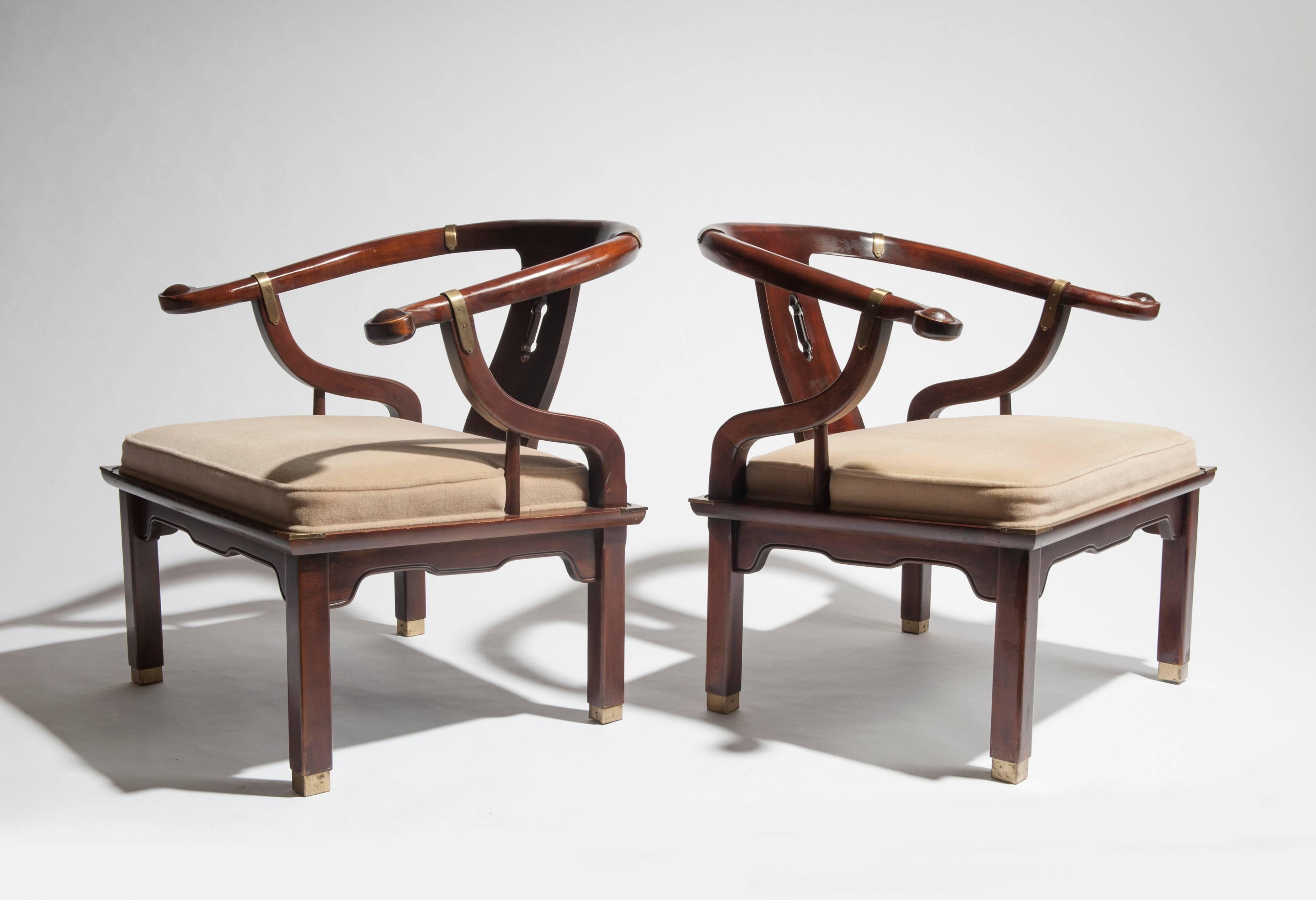 Appealing pair of Asian Ming inspired lounge chairs by Century Furniture. Chairs are substantial and quality built with solid wood and brass details.