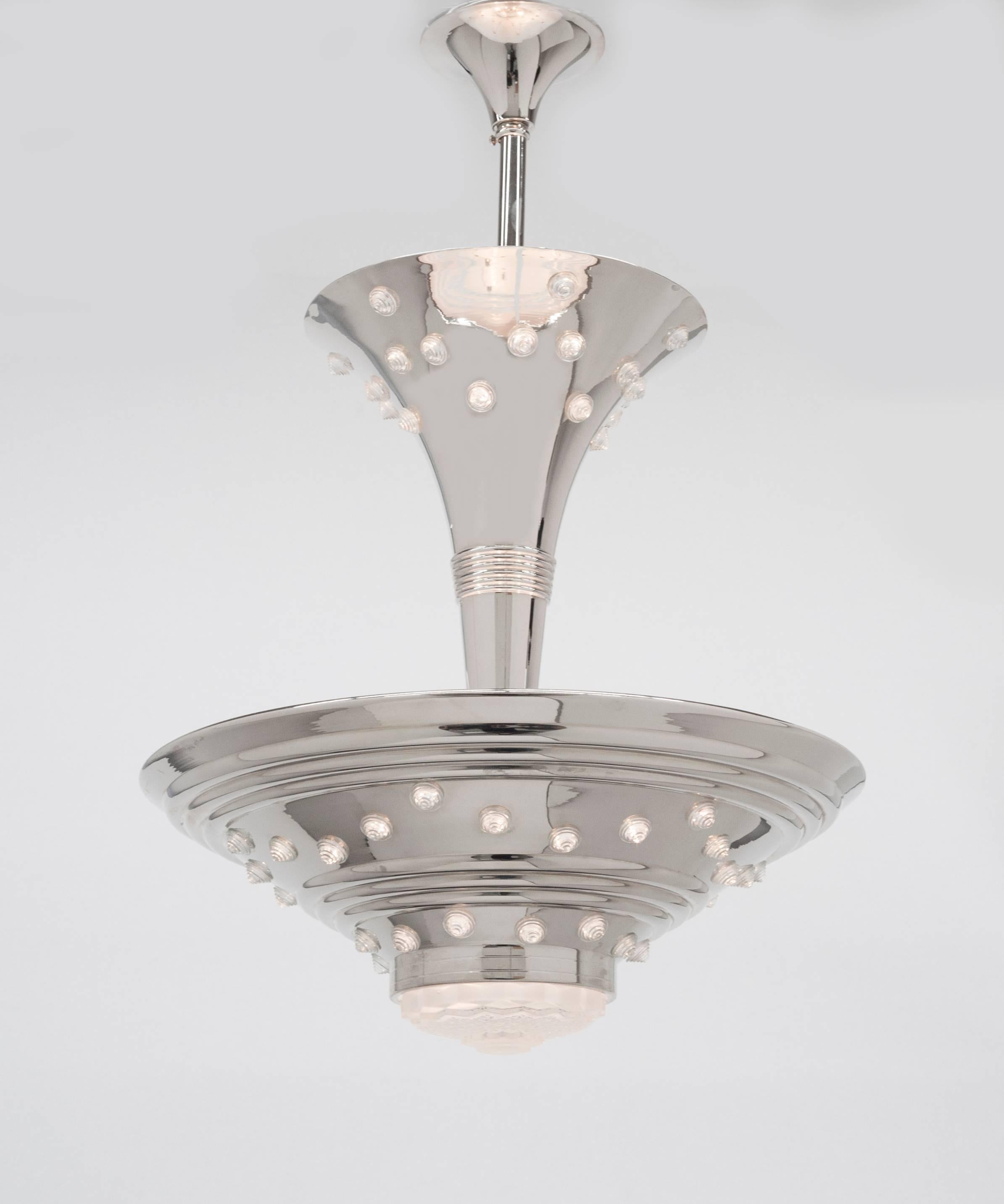 Unusual and beautiful Art Deco chandelier from France, 1930s.  Chandelier is polished nickel and glass.  There are a total of eight lights. Condition is excellent and there is new wiring.