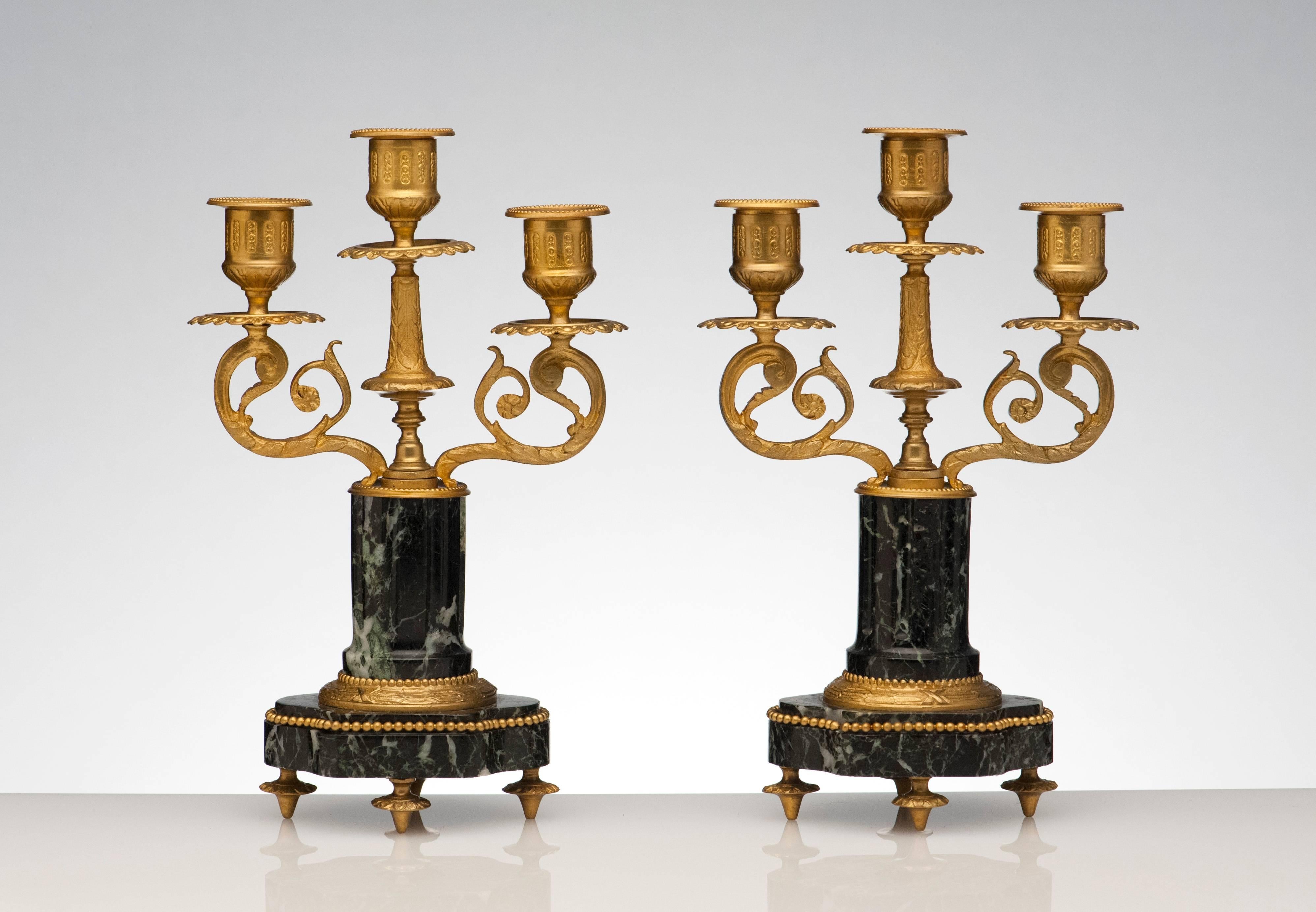 Finely made pair of candelabras from France, 1920s. Beautiful bronze detailing. Carved marble columns and base. Condition is excellent.