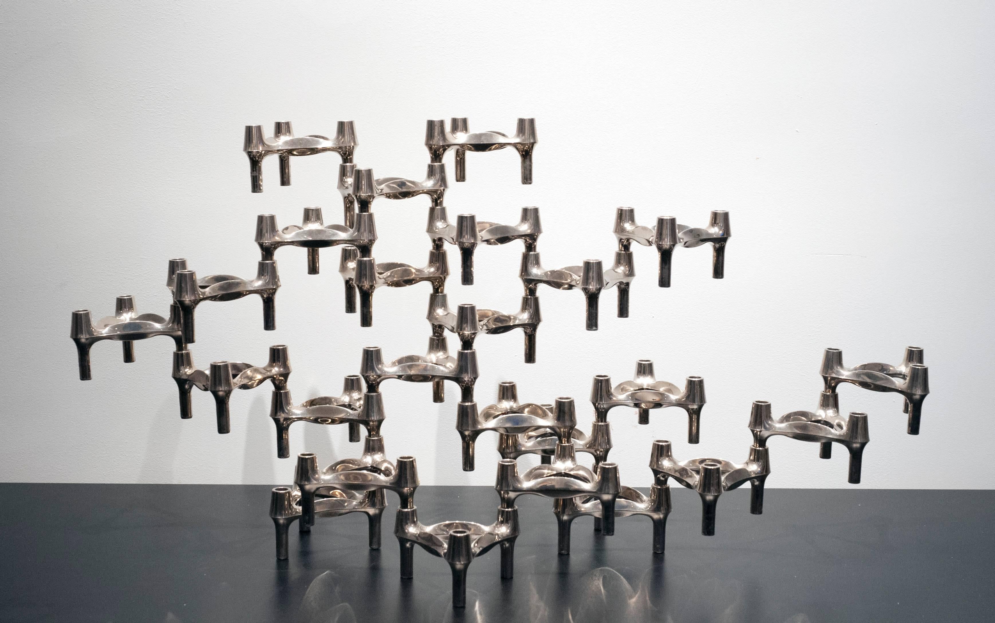 Striking set of 25 Nagel candleholders manufactured by BMF of Germany. Clever inter-locking and stacking design allows for endless configurations.  The sculptural quality makes it a great centrepiece. Quality made of solid chromed nickel. Condition