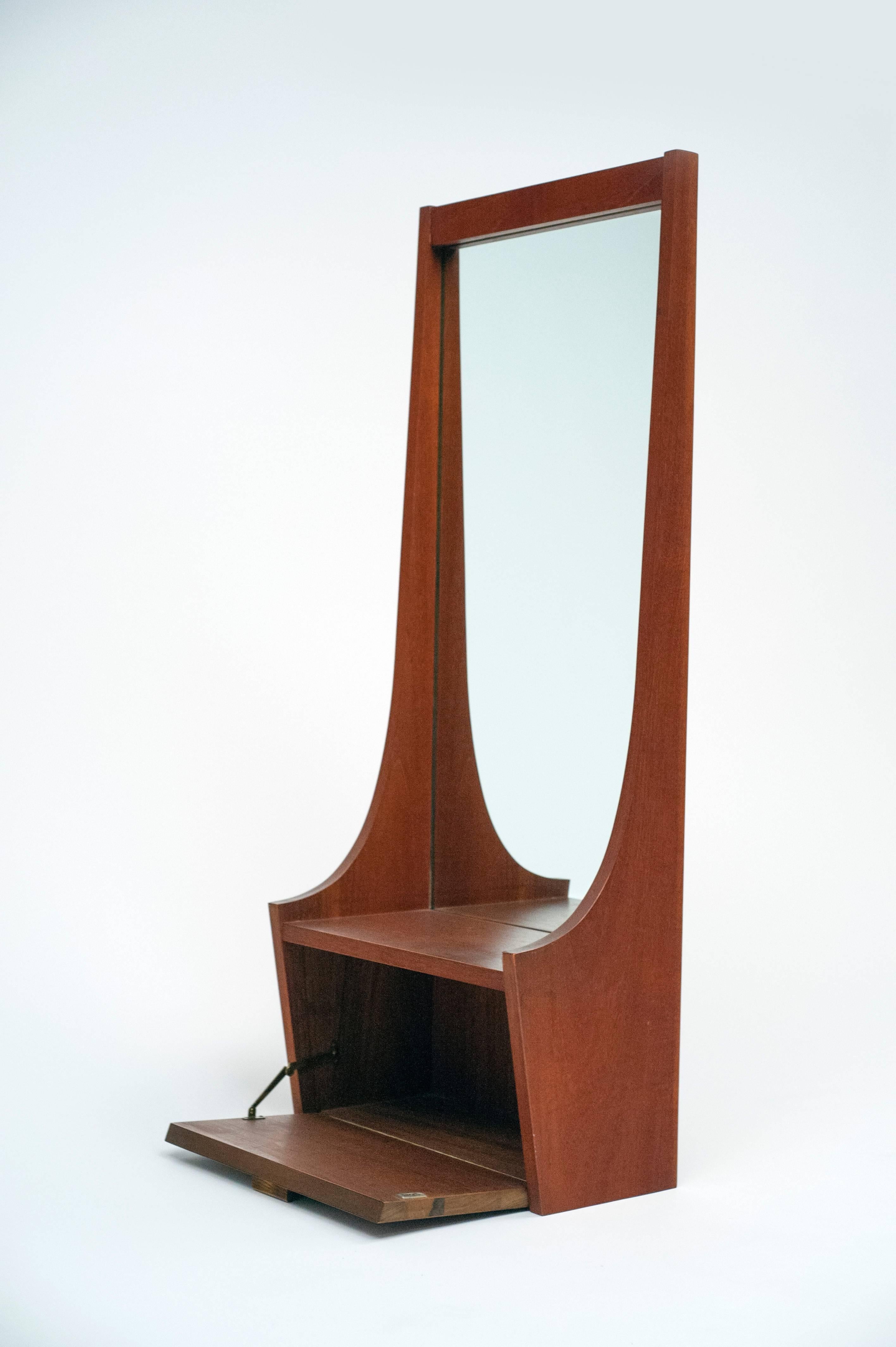 A large functional entry way mirror with shelf and cabinet.  