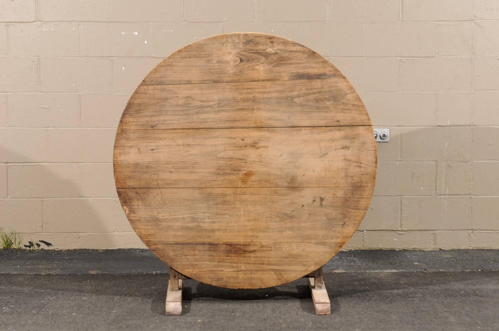 A rustic round French wine tasting table from the early 20th century with tilt-top, butterfly wedge and trestle base. We snap these beauties up whenever we can because they are the most useful tables we’ve come across! With their tilt top, they