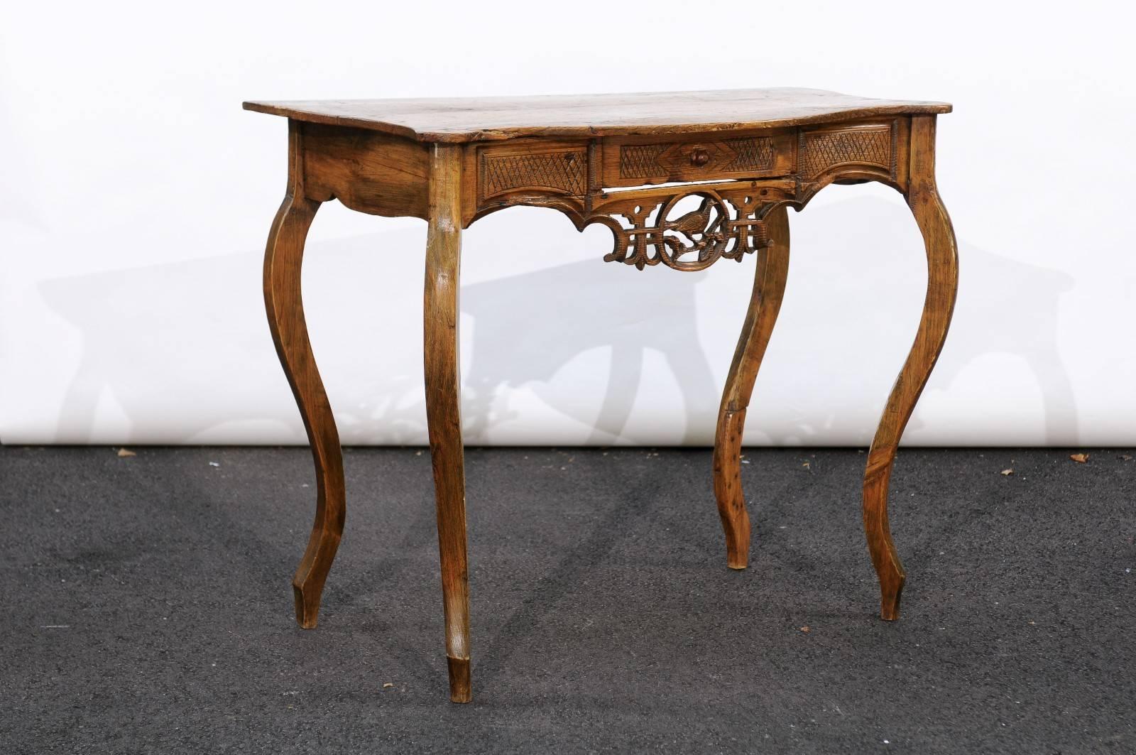 An exquisite French Louis XV style pine desk from the Jura region in Eastern France, bordering Switzerland. Look at those legs! And the intricate carving on the apron depicting a delicate bird in a carved medallion. Magnifique! Finding unique pieces