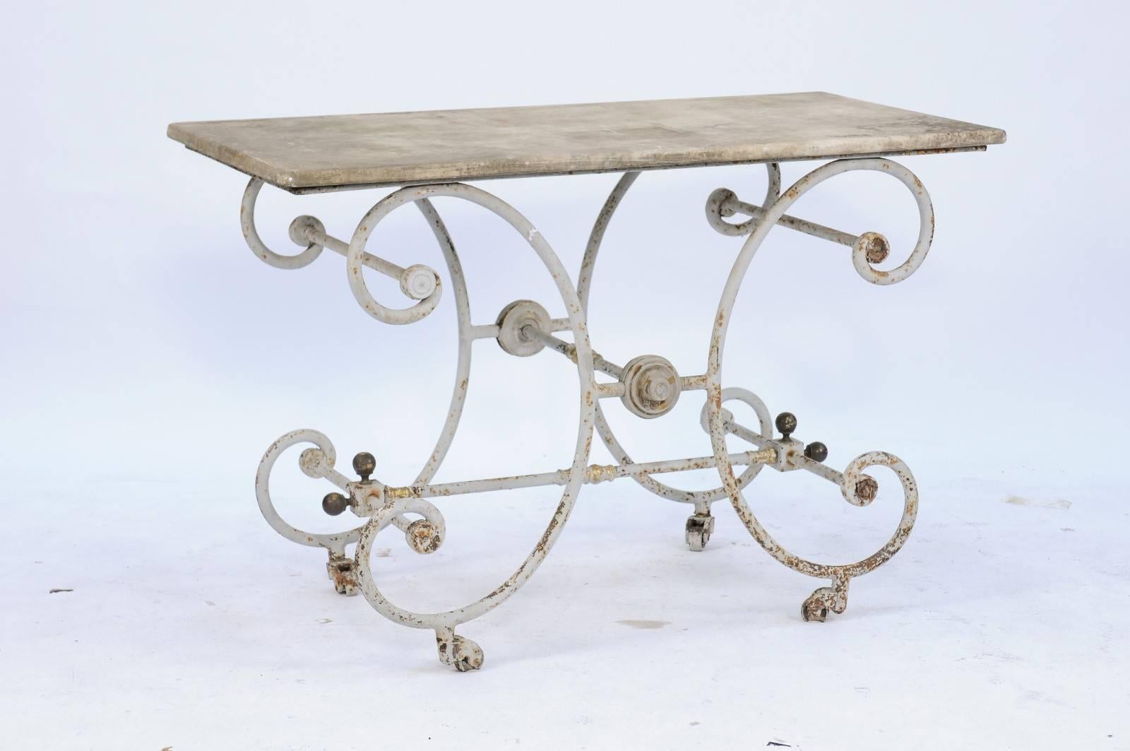 A French early 20th century baker's table with stone top and C-scroll shaped iron base. We love a gorgeous baker’s table, and this one from the 1900s doesn’t disappoint! We were first drawn to the beautifully worn creamy stone top, but it was the