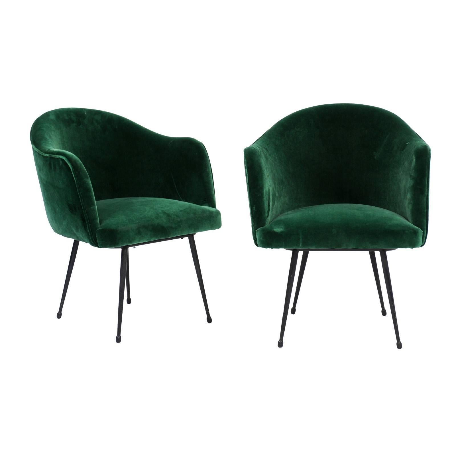 A pair of French 1970s green velvet upholstered tub chairs from the mid-20th century raised on four tubular splayed legs. There was just something about the vibrant – but sophisticated – green velvet of these charming chairs that caught our eye.