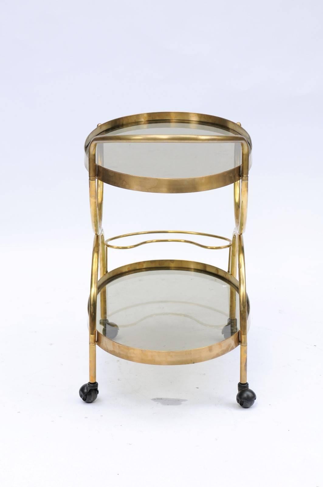 Italian Florentine, 1950s, Two-Tiered Oval Brass and Glass Bar Cart with Curvy Lines