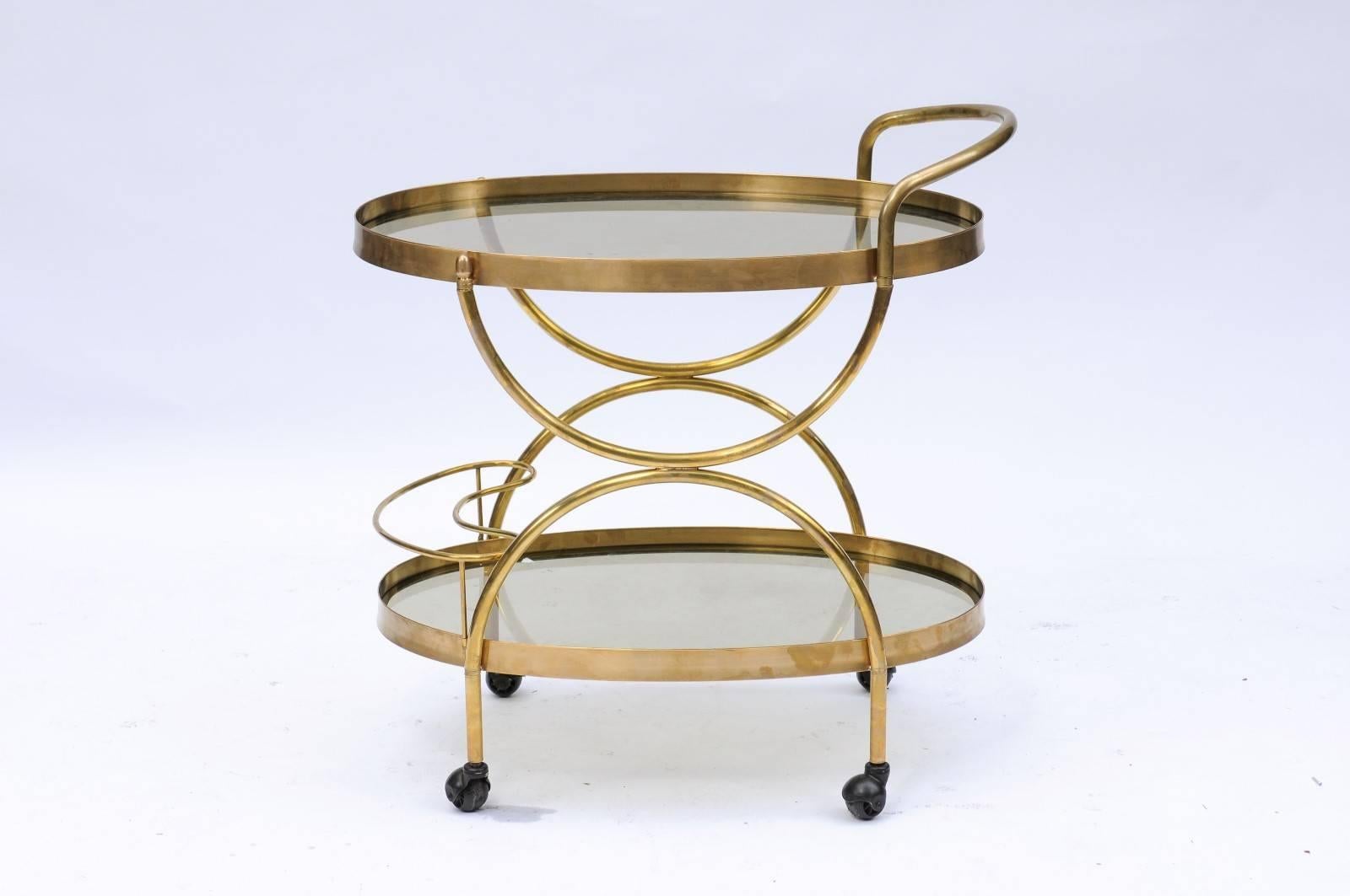 Florentine, 1950s, Two-Tiered Oval Brass and Glass Bar Cart with Curvy Lines In Good Condition In Atlanta, GA