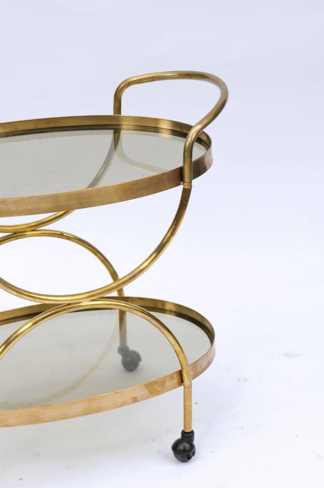 20th Century Florentine, 1950s, Two-Tiered Oval Brass and Glass Bar Cart with Curvy Lines