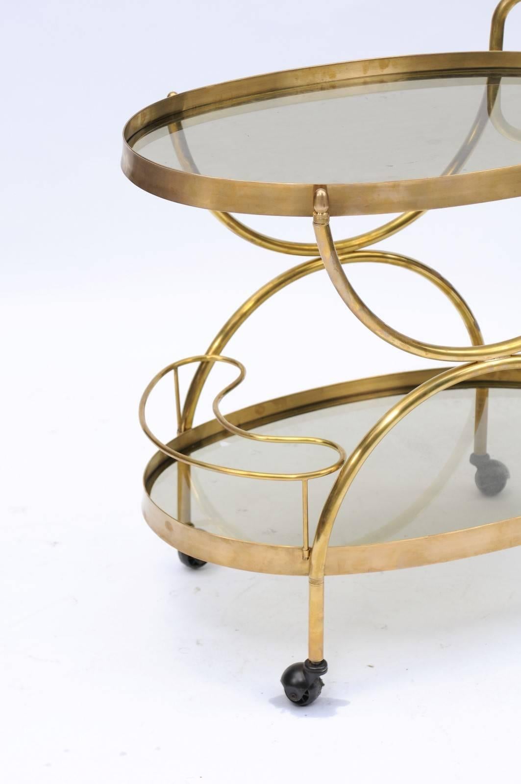 Florentine, 1950s, Two-Tiered Oval Brass and Glass Bar Cart with Curvy Lines 1
