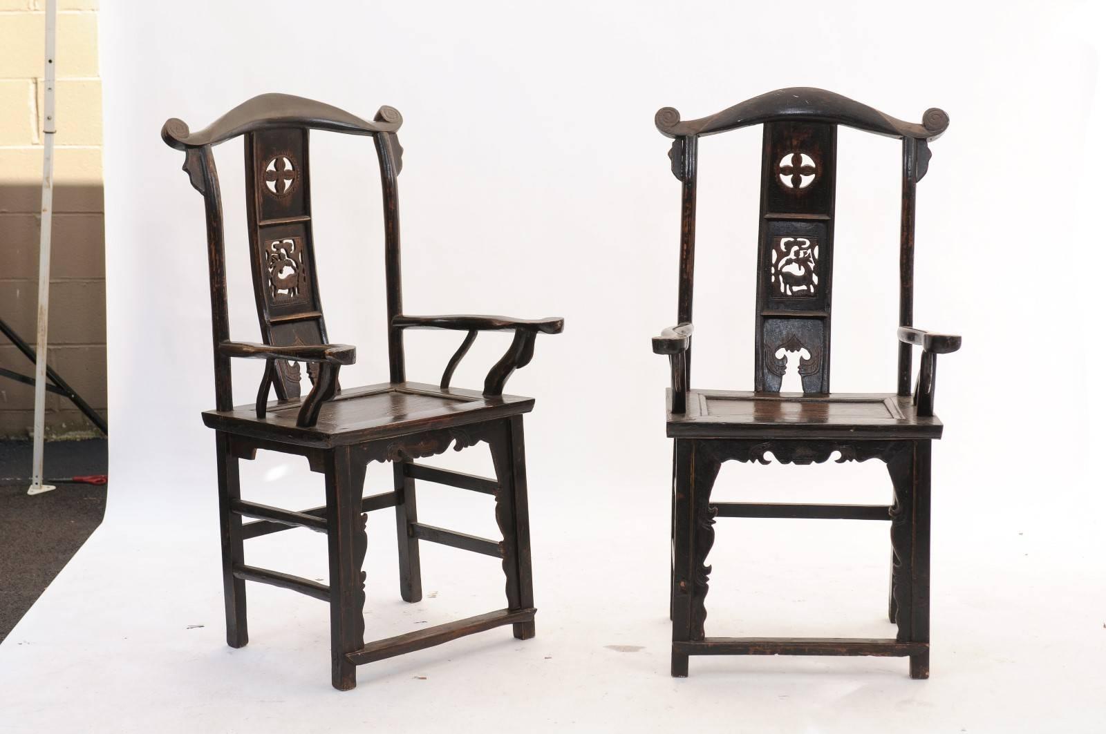 A pair of chinoiserie carved wood armchairs with pierced splats and scrolled arms with dark wood finish from the 1890s. Because we are not experts in chinoiserie style chairs, we can’t vouch for the origins of this pretty pair. What we can tell you