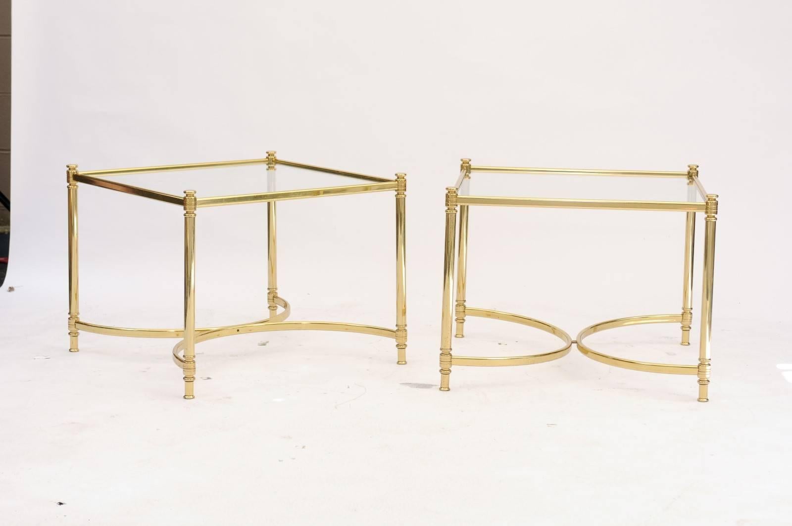 A pair of Mid-Century Modern French square brass and glass side tables with half-moon stretchers. We love their sexy but Classic vibe, and the interlocking demi-circles add a fanciful touch. Their linear silhouettes are indeed softened by the gentle
