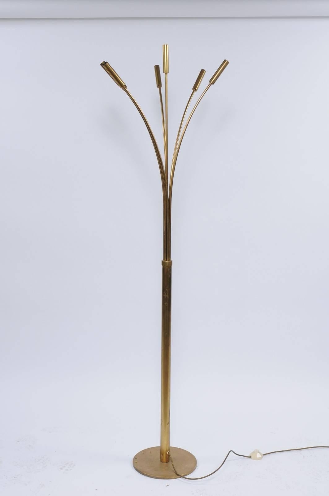 An Italian vintage brass seven-light floor lamp from the 1970s. We jump when we find tall, thin and graceful brass lamps like this one. The perfect marriage of art and function, its seven beautifully arched arms come out of a solid brass base like