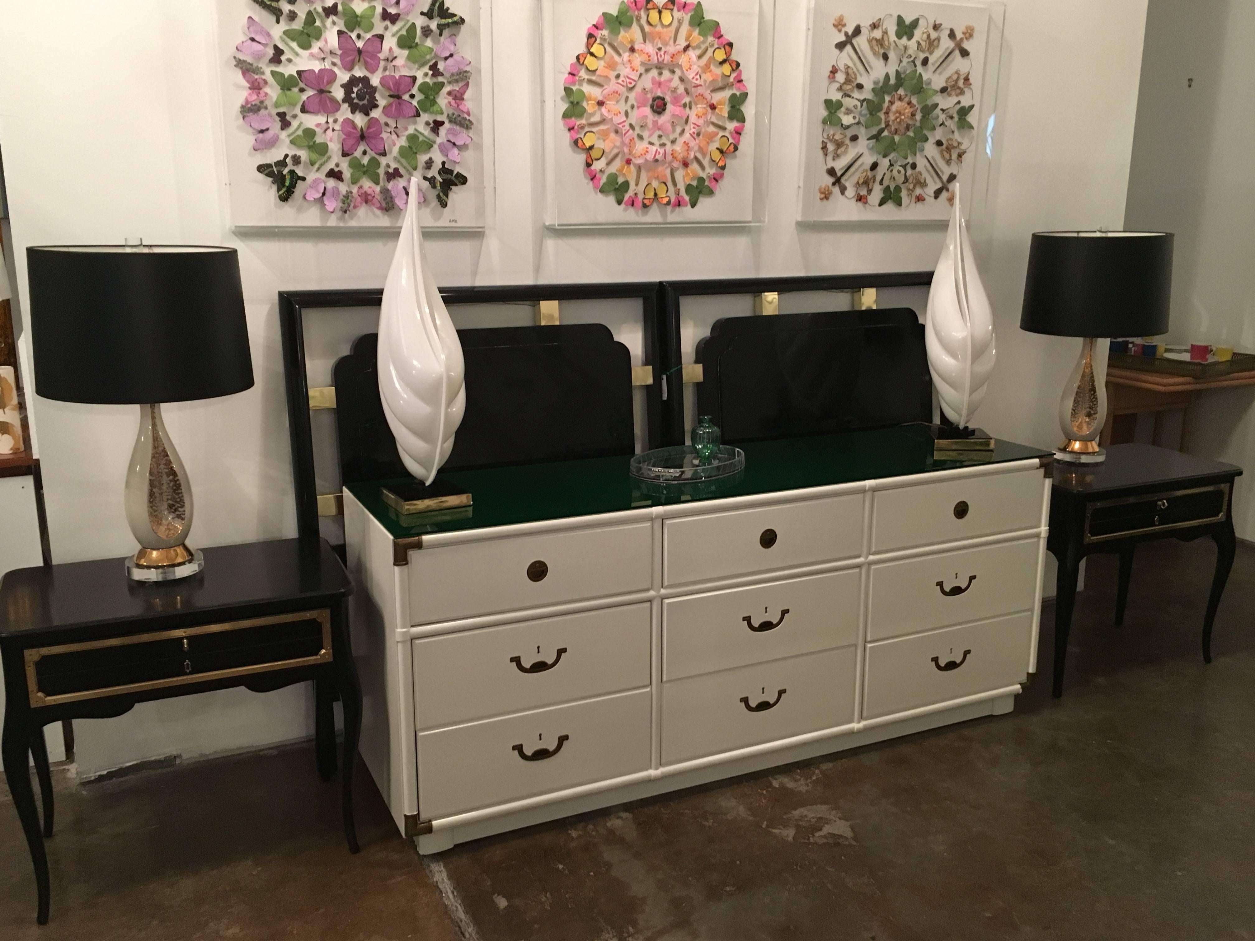 Offered is a pair of signed Hollywood regency Grosfeld House black lacquer and brass side tables. Grosfeld House Furniture Company led the up-market modern yet classical movement in furniture design and manufacture starting in the early 20th