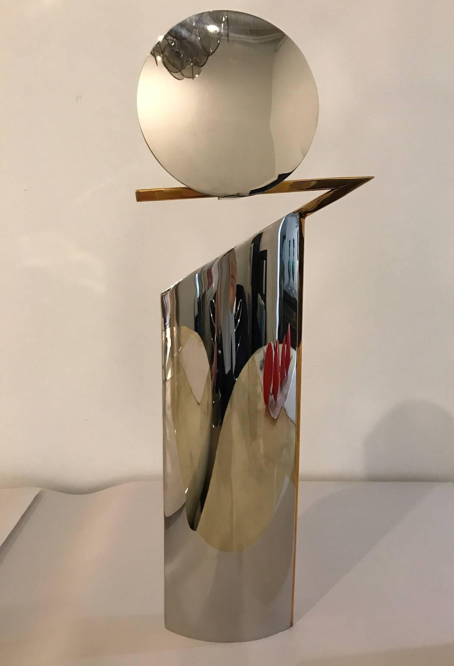 Offered is a Mid-Century Modern Italian set of three graduating size chrome and brass candlestick holders in the style of Lino Sabattini. This set is elegant yet right on trend for today's decor. The set is sleek and sculptural and looks fabulous in