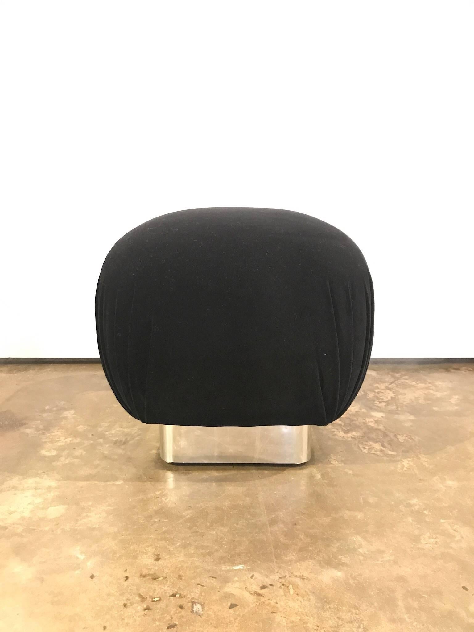 Offered is a Mid-Century Modern, newly upholstered in black velvet and square chrome base Karl Springer style round pouf. This very glamorous piece will look fabulous in almost any room with any style of furniture. Great for placing a tray for