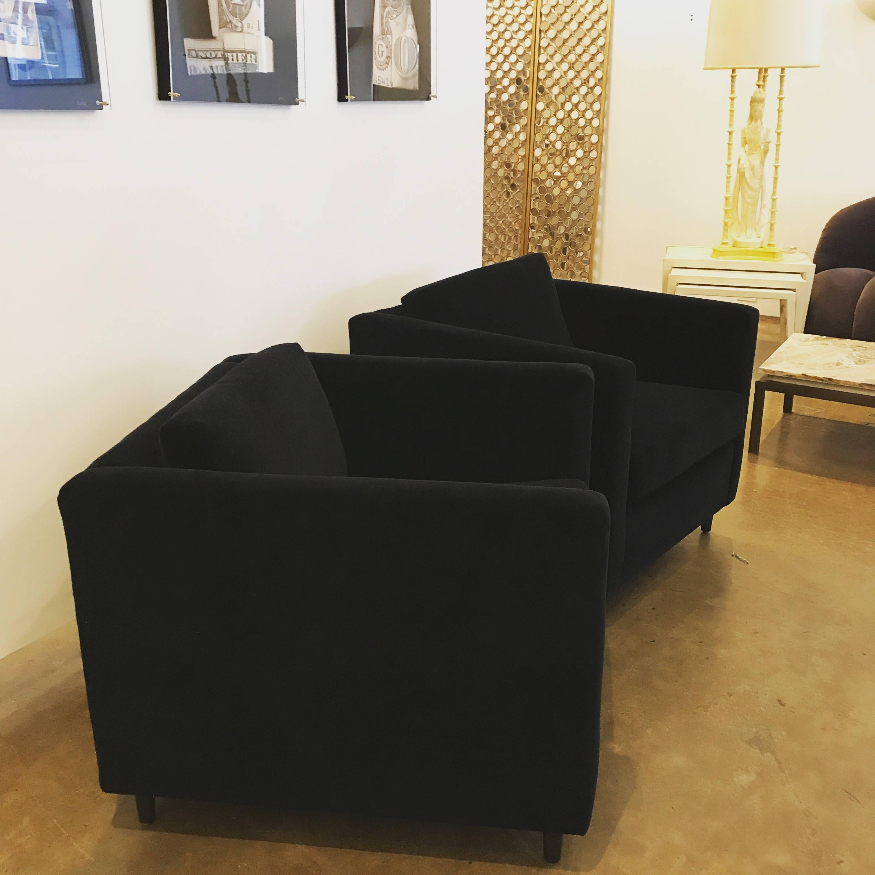 Offered are Mid-Century Modern newly upholstered Harvey Probber style "tuxedo" pair of club chairs in a black cotton velvet with ebony stained wood legs. The style and comfort of this pair are on point and would look great with just about