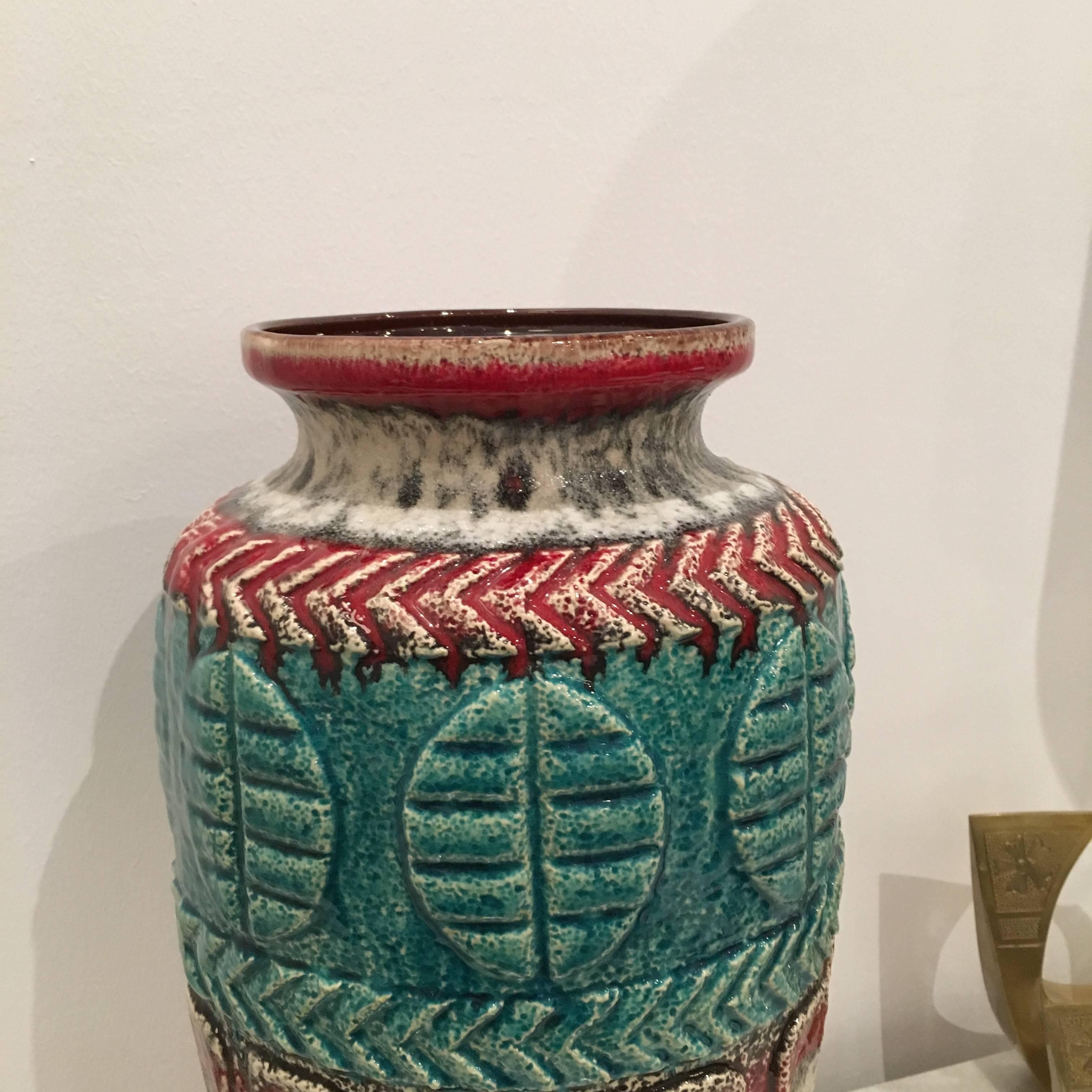The offered vase is signed by one of West Germany's most prolific pottery manufacturer, Bay.  This piece is quite beautiful and highly representative of mid-20th century modern West German pottery with vivid colors of turquoise blue, cherry red and