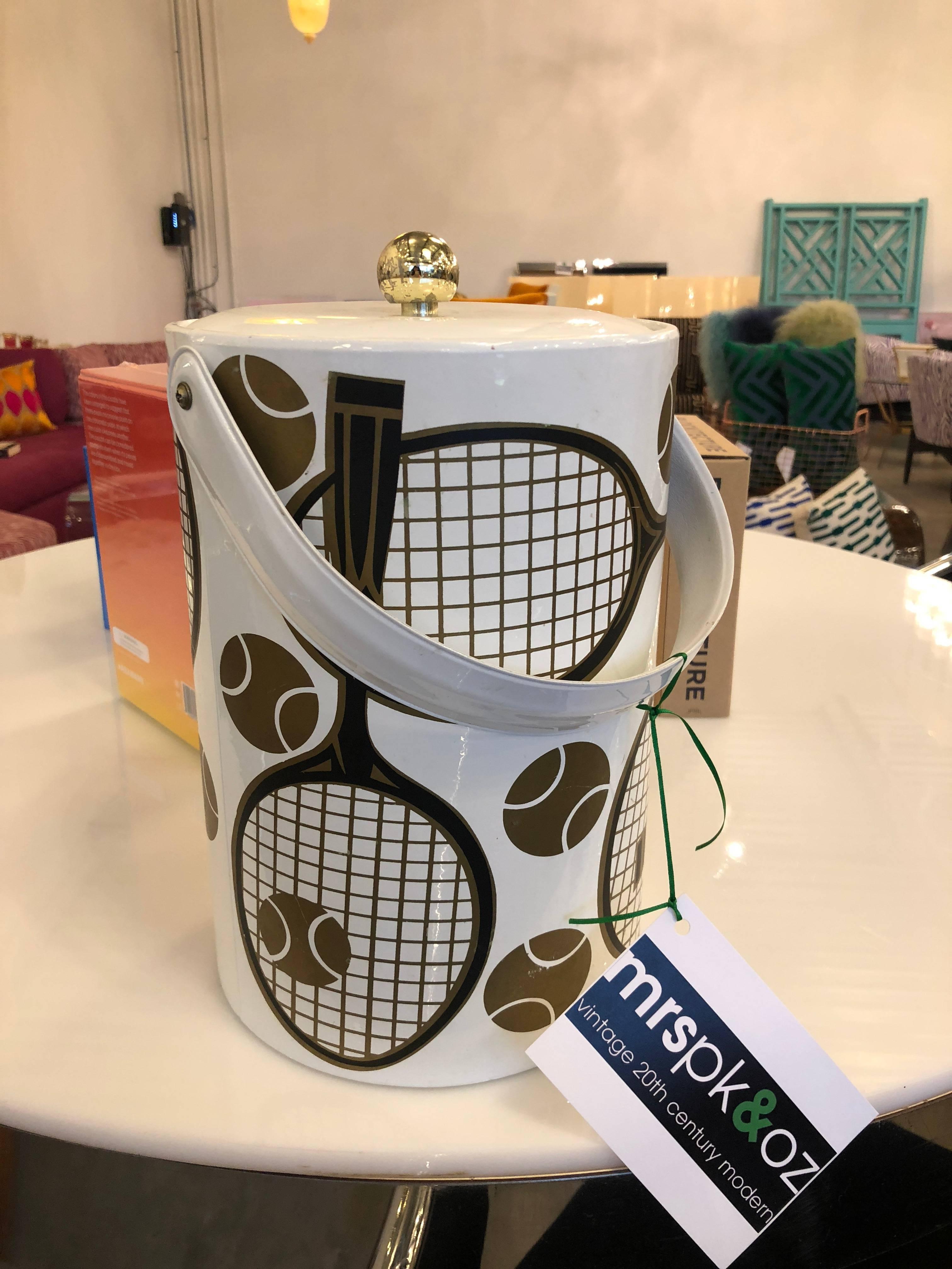 Ready, set, match! Offered is a Mid-Century Modern groovy signed Georges Briard tennis themed ice bucket and lid (gold ball top) of shiny white vinyl or patent leather with black, glitter gold, silver and copper tennis racquets and balls and a pair