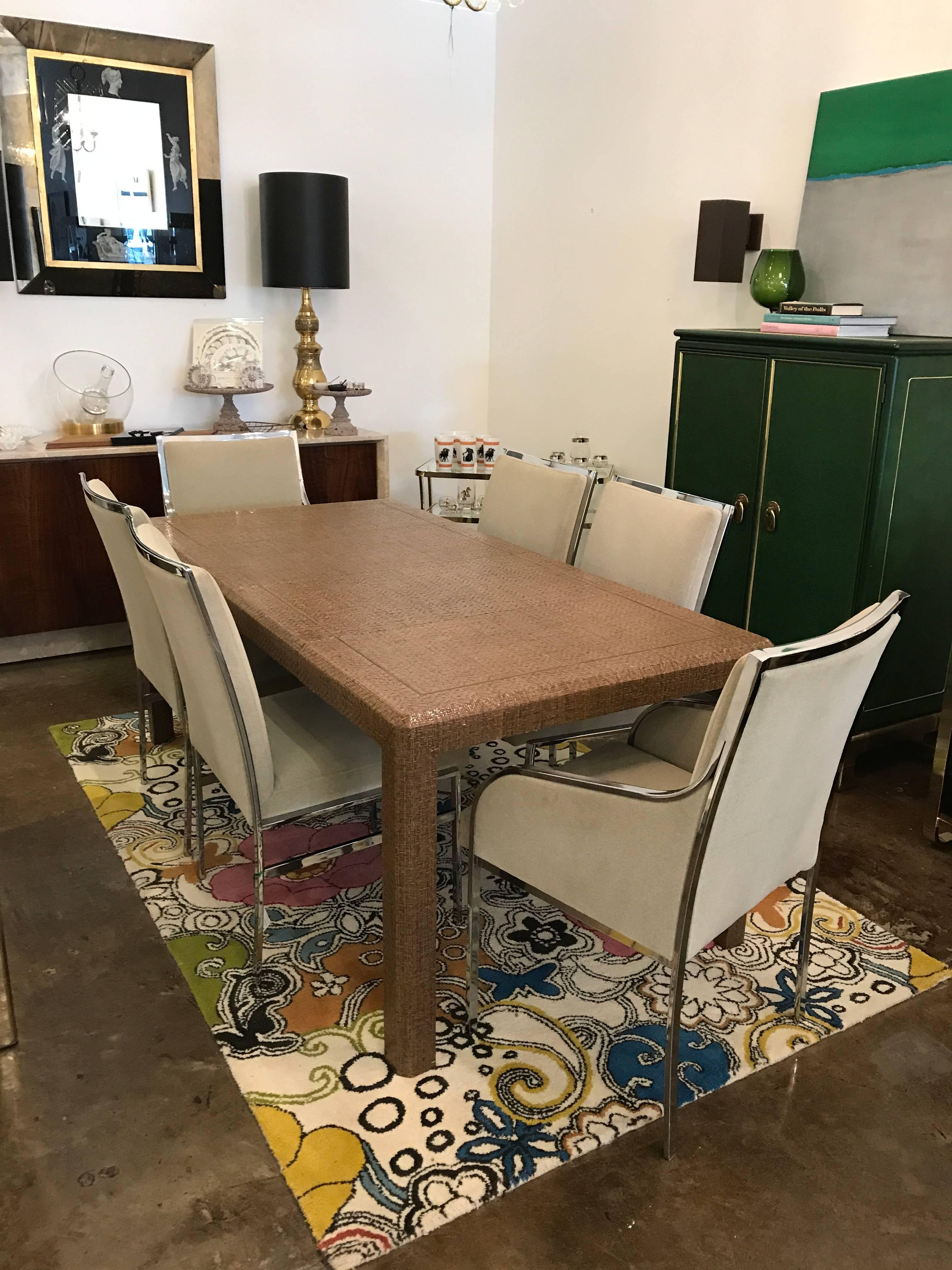 Stunning gracious lacquered wicker, raffia and/or rattan game table with inlaid brass. Add two matching leaves and you have a dining table. Great for tighter spaces where a place setting for four is the practical use. However, for those times that