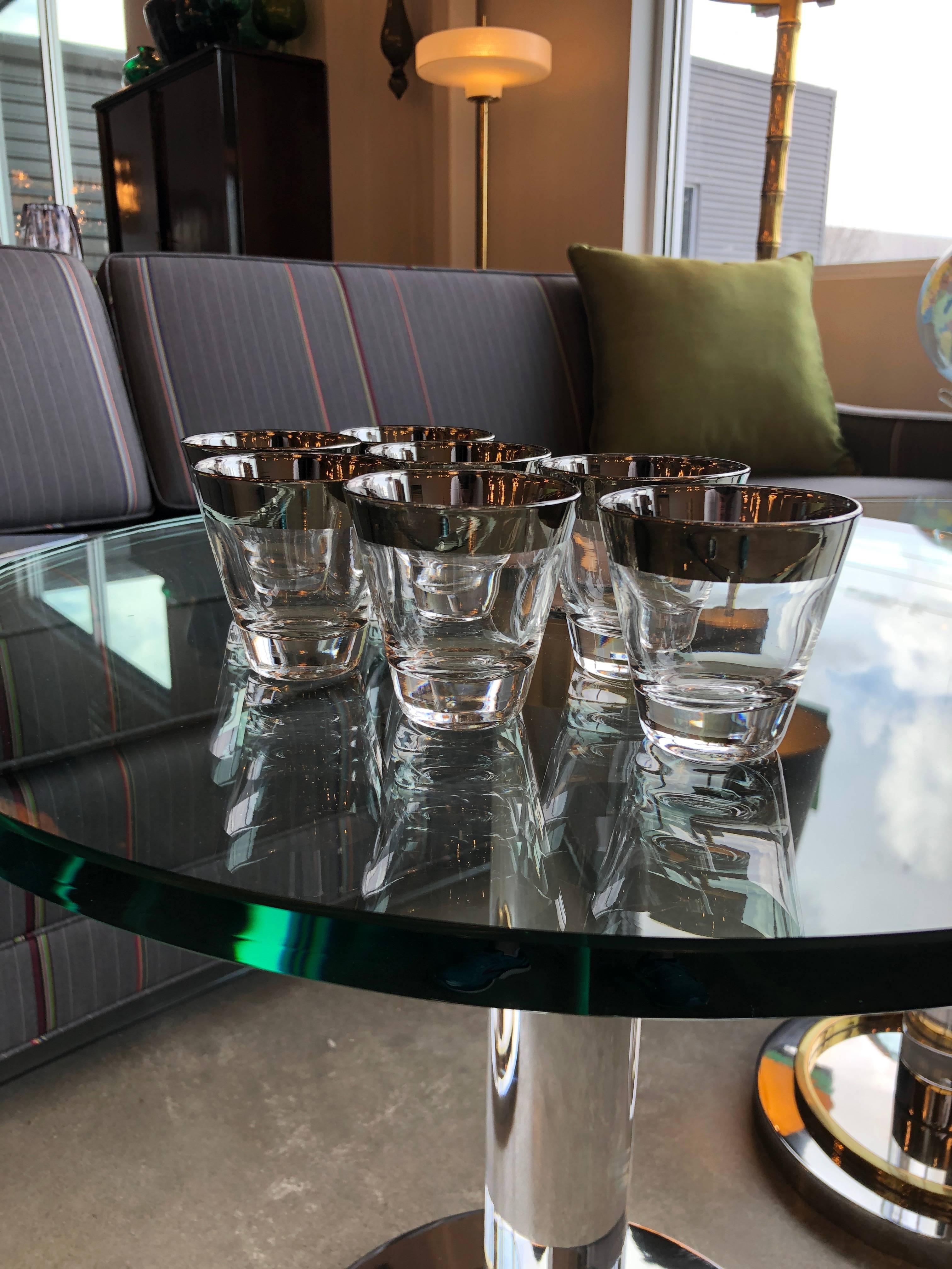 Offered is a set of seven Mid-Century Modern Dorothy Thorpe silver overlay / silver rimmed shot cocktail glasses. Perfect for all of the new 