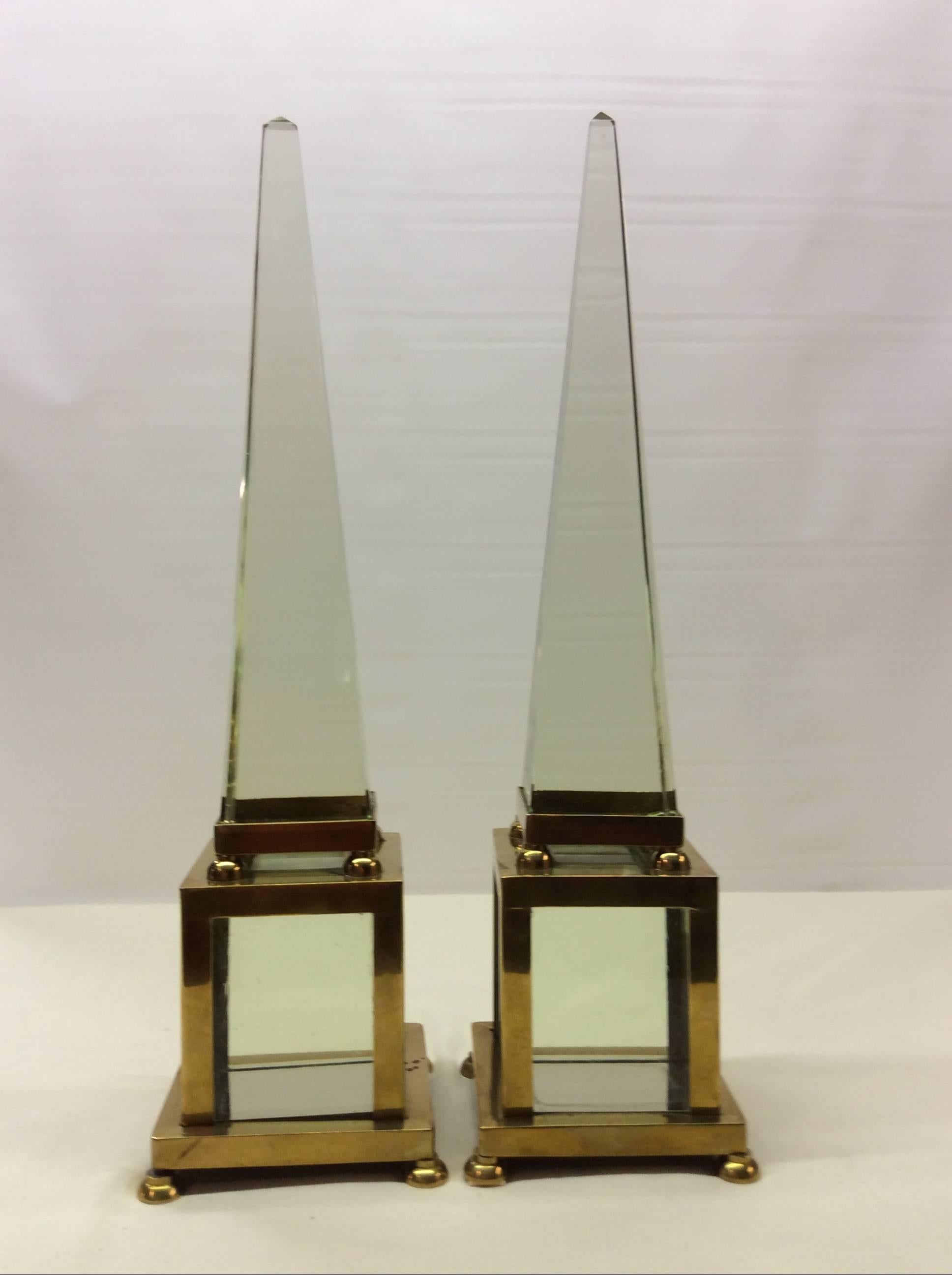 Impressive is not sufficient to describe there Classic pieces.
Pair of exquisite Mid-Century obelisks
Extraordinary quality brass encased pure prismatic crystal.
Crafted like pieces of fine jewelry. 
The heavy weight and density of the crystal