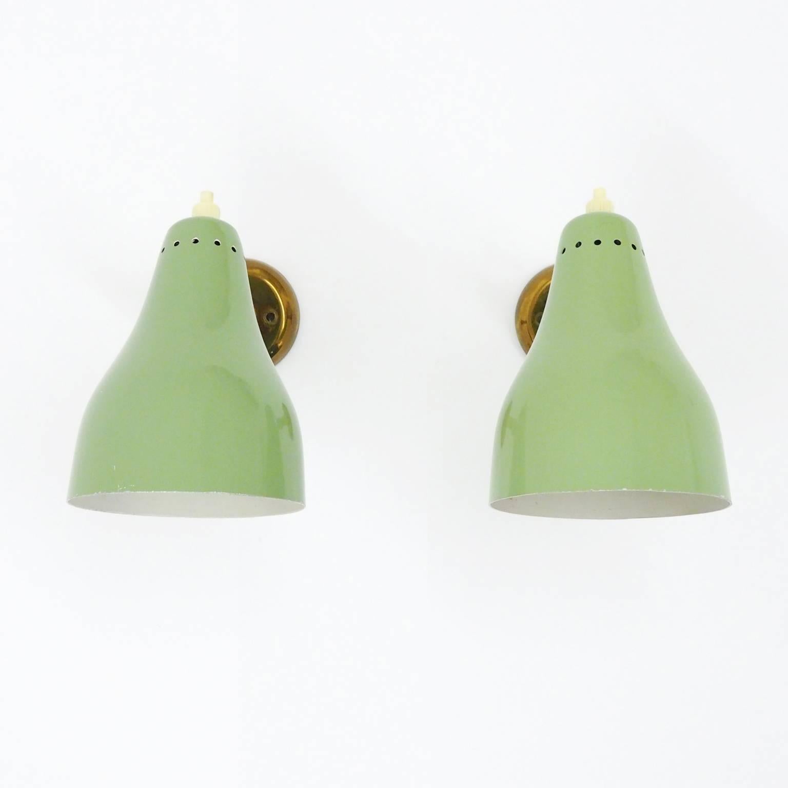 Charming pair of pastel mint colored sconces attributed to Giuseppe Ostuni, circa 1950. These appear to have been barely used and are in beautiful original condition: just a few specks of paint loss and a rich, deep tone to the brass. One brass and