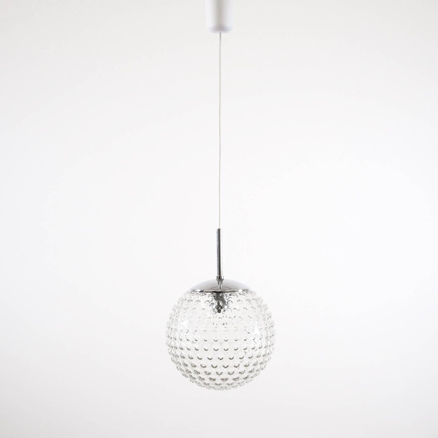 Clear bubble glass pendants with chrome hardware by Staff Leuchten, Germany, produced in 1966. Designed by Rolf Krüger, chief designer by Staff from 1965-1970. Excellent condition and stunning space-age light effect. One E27 socket (100W) with new