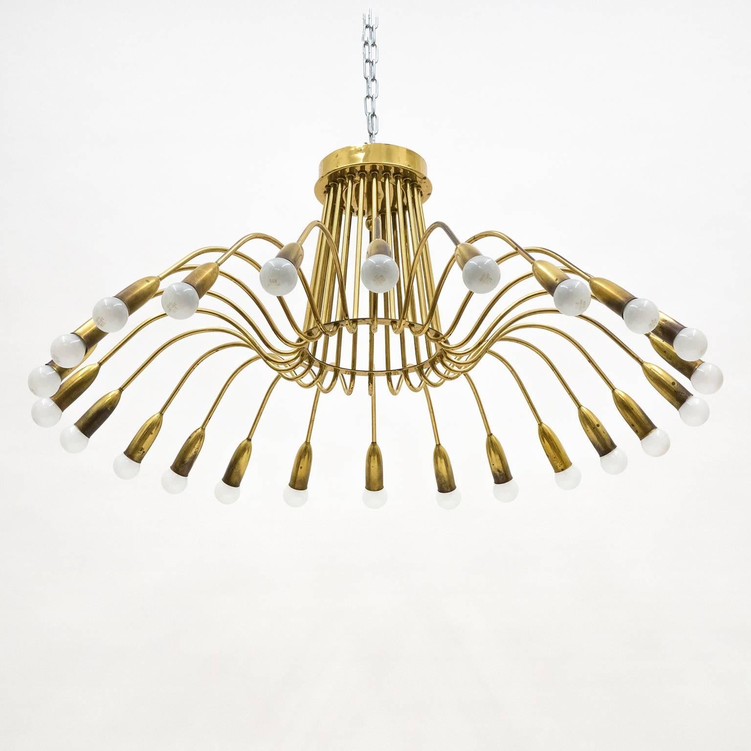 Spectacular 24-arm brass chandelier from the 1940s which attaches directly to the ceiling. Lovely age-related patina, mostly on the socket covers, gives this brass beauty a very distinct personality. Each arm has one E14 socket with new wiring.