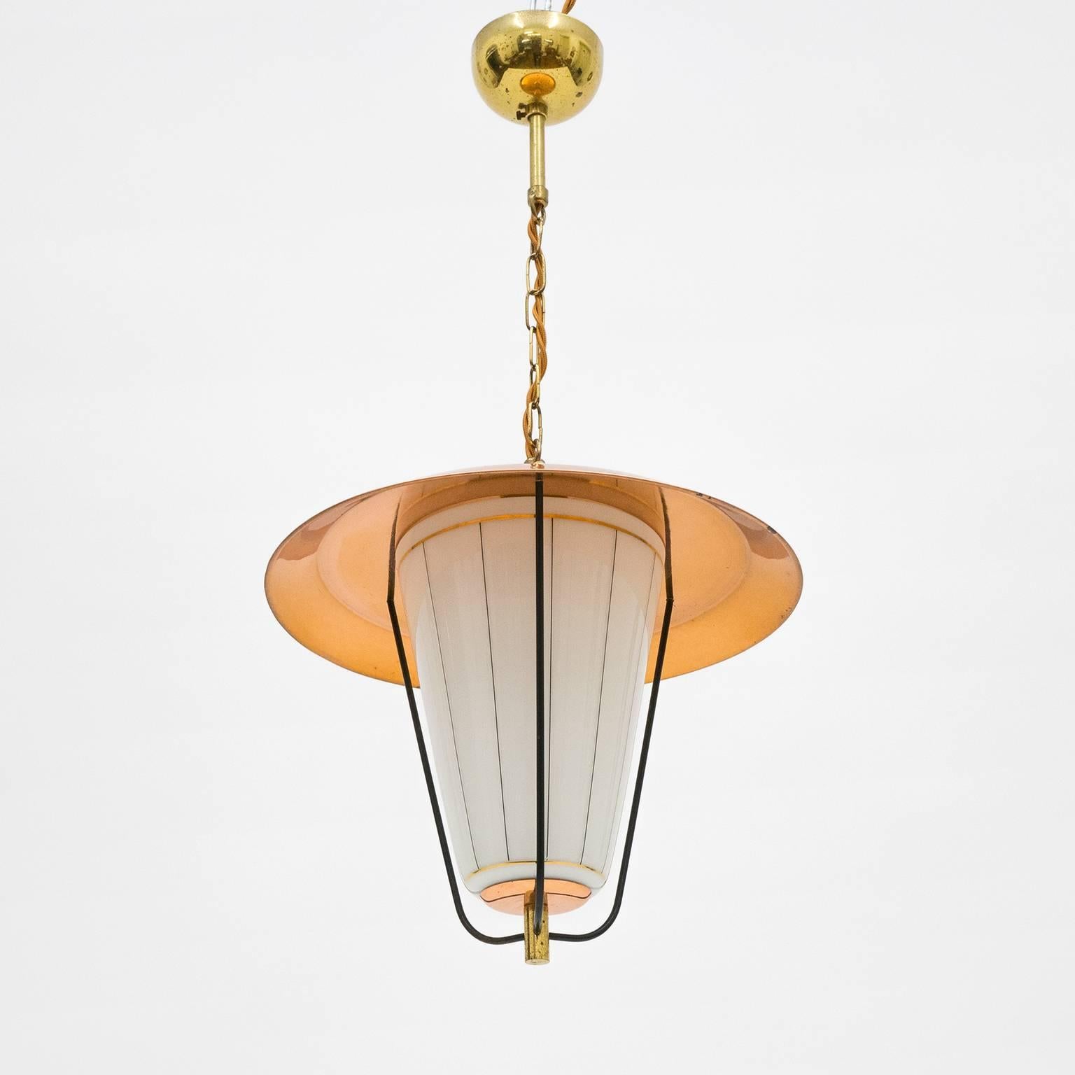 Lovely Mid-Century lantern pendant from Austria, 1950s. Subtle mix of colors and materials with brass, a copper shade and an opaline glass diffuser with black and gold pinstripe decor - has a nice 'Modernist meets Art Deco' attitude to it. Very nice