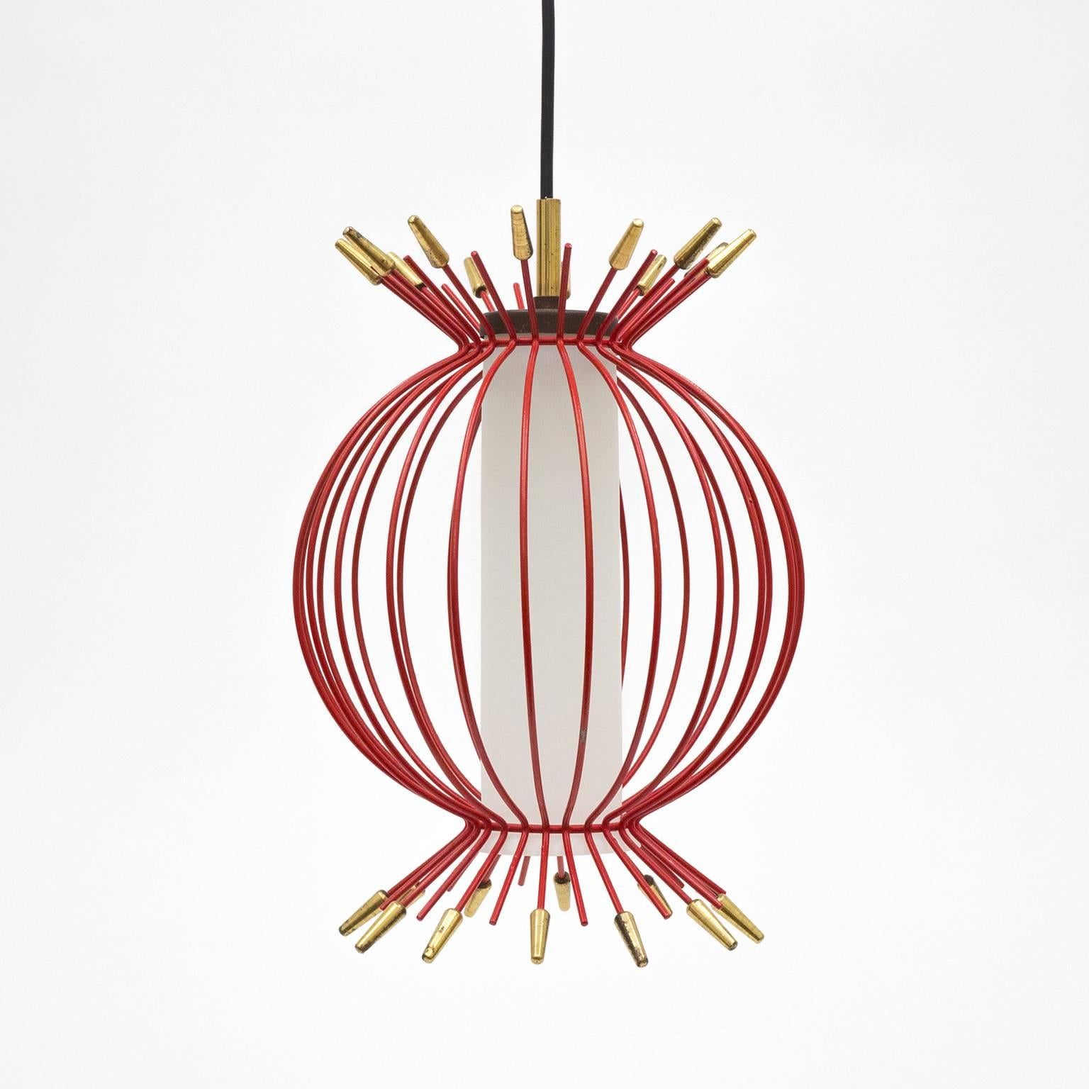 Delightful Mid-Century cage pendant, circa 1960. A red lacquered wire cage with brass details sits atop a cased and satiated glass diffuser. Very nice original condition with light loss of paint and a lovely patina on the brass. One E14 socket with