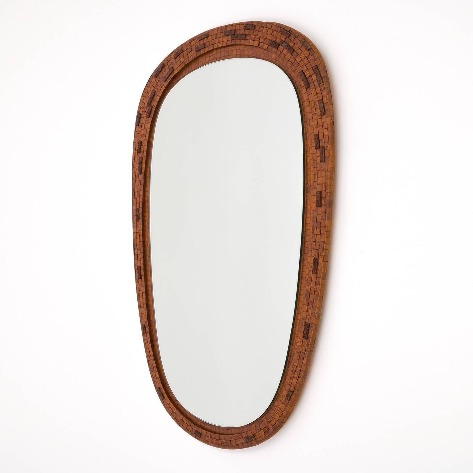 Very unique tapered oval mirror with a rare teak mosaic design. Beautifully crafted with tiers of varying curves and a lot of attention to detail, all the way to the veneer on the backside.