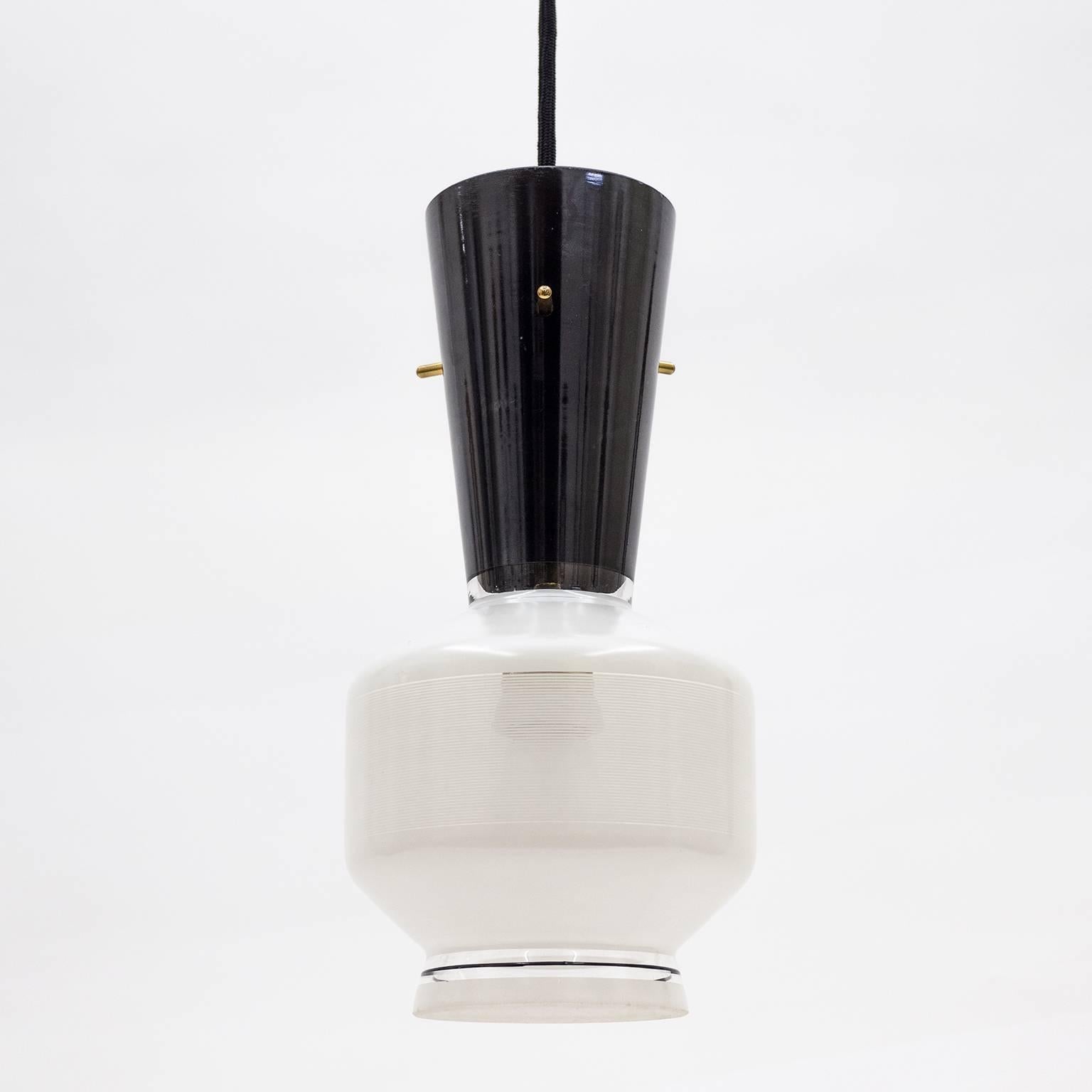 Graphical pair of Italian black and white enameled glass pendants from the 1950s. The clear blown glass bodies have a lovely midcentury shape and are enameled in black and white - partially in very fine pinstripe lines to create a semi-translucent