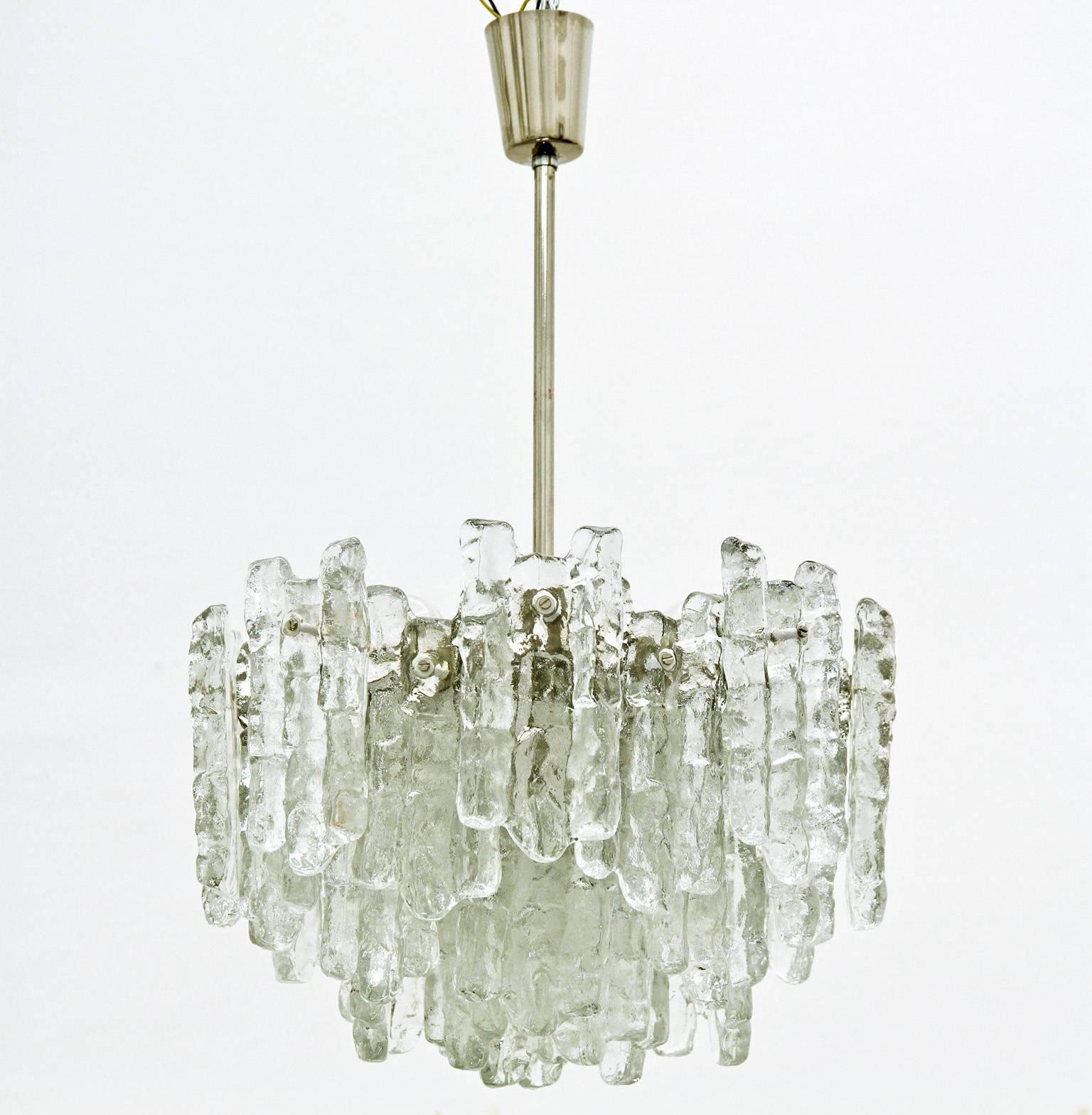 Dramatic ice glass chandelier by Kalmar, Vienna. 28 icicle shaped glass pieces are arranged in three-tiers and lit by nine-light to create a stunning light.