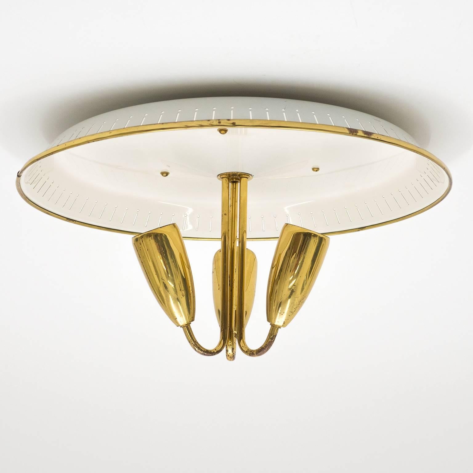 Stylish three-arm brass flush mount with a large perforated and lacquered reflector. Very good overall original condition with some age-related patina on the brass. Three E27 sockets with new wiring.