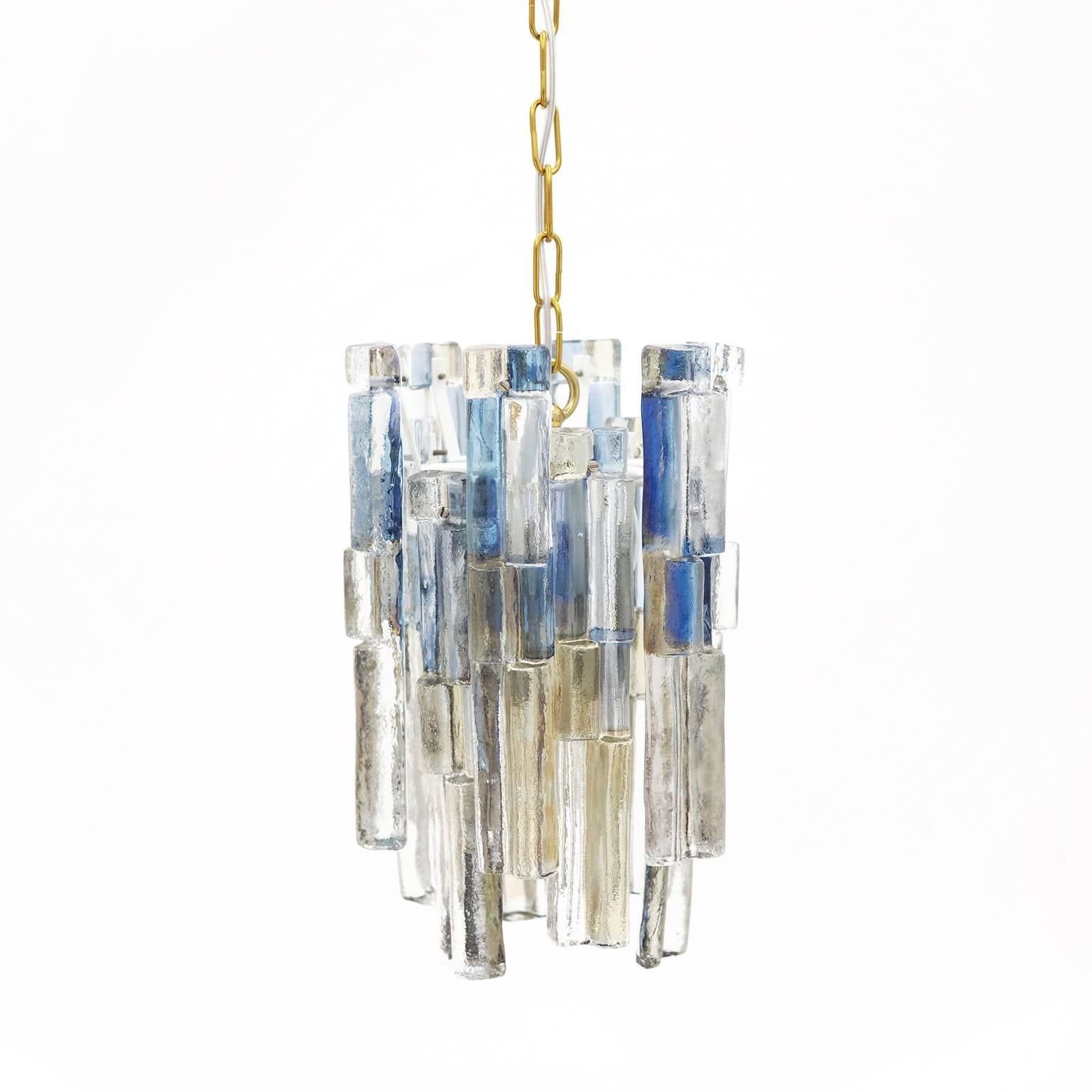 Exceptional and very rare multicolored Kalmar chandelier. 12 large textured tinted glass elements are mounted on a white lacquered steel body suspended by a brass chain and canopy (with manufacturers label). There a six E14 Sockets (40W max each) to