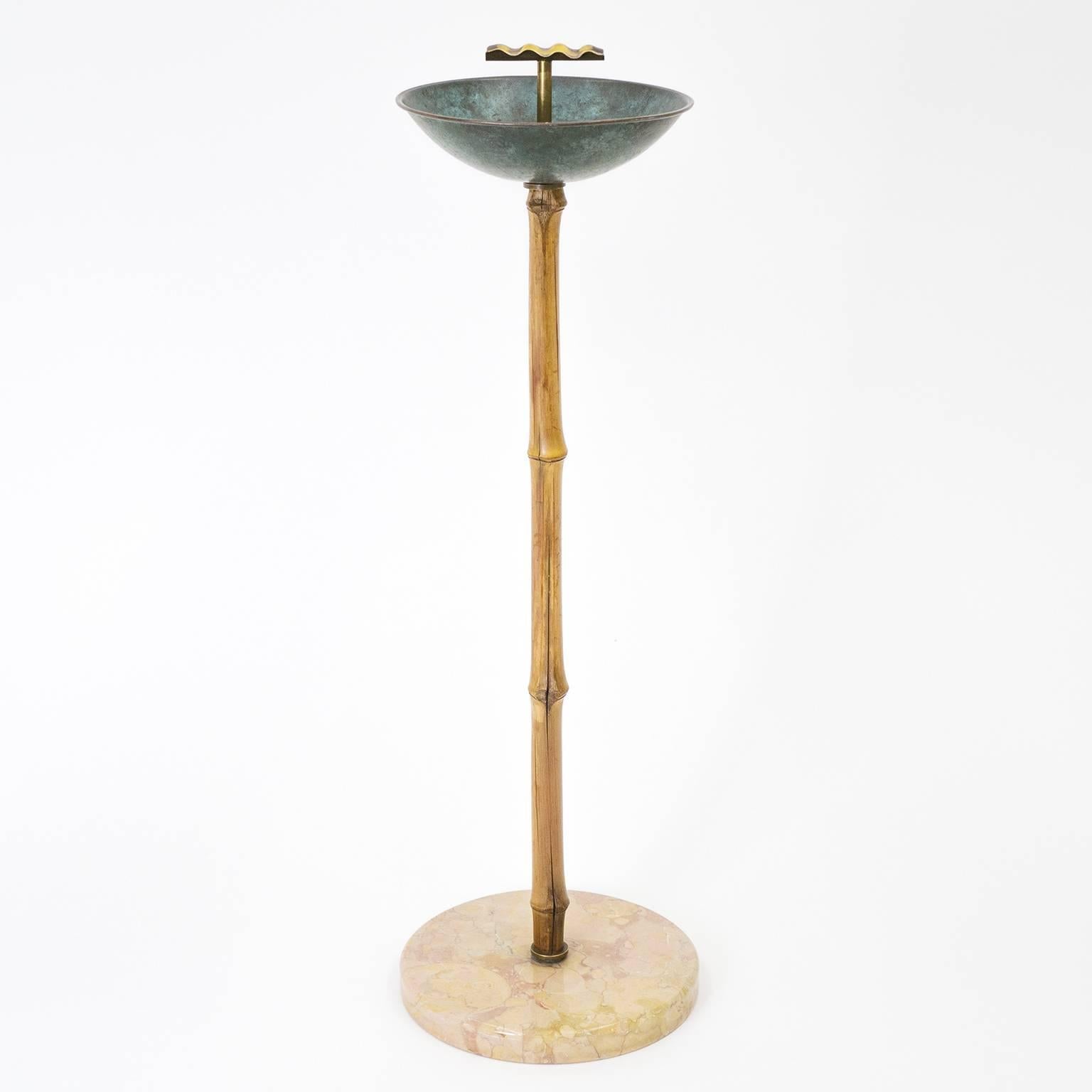 Unique Mid-Century Austrian ashtray stand in the manner of Hagenauer and Auböck. Stone base with bamboo stand and patinated brass cup and cigarette rest. Beautiful original condition with a nice patina on the brass and bamboo.