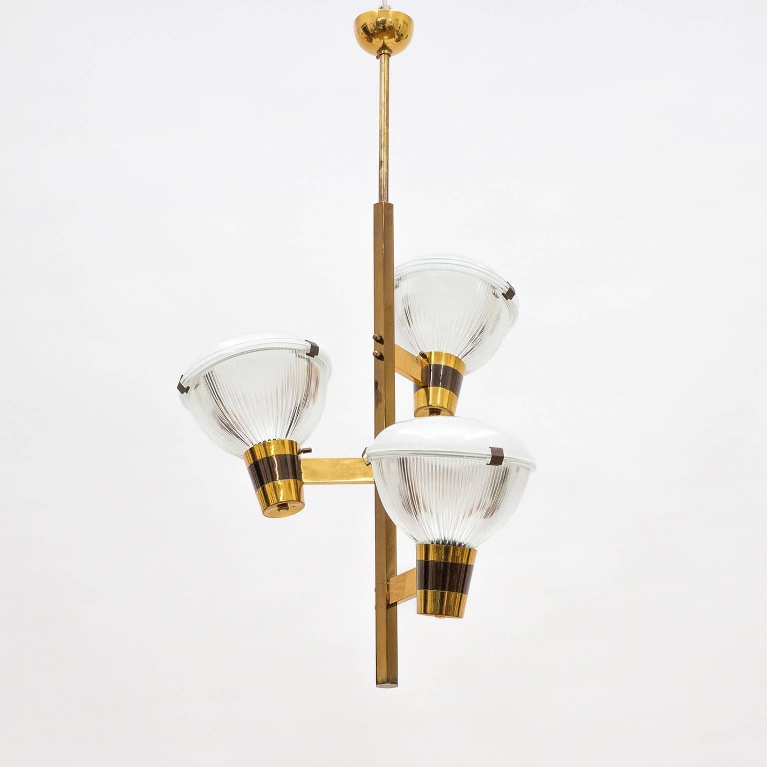 Excellent Stilnovo brass chandelier from the late 1950s. The entire hardware is made of brass that has been patinated in various degrees. Three large (7.5inches/19cm diameter) Holophane glass elements each house one E27 socket with new wiring. Very