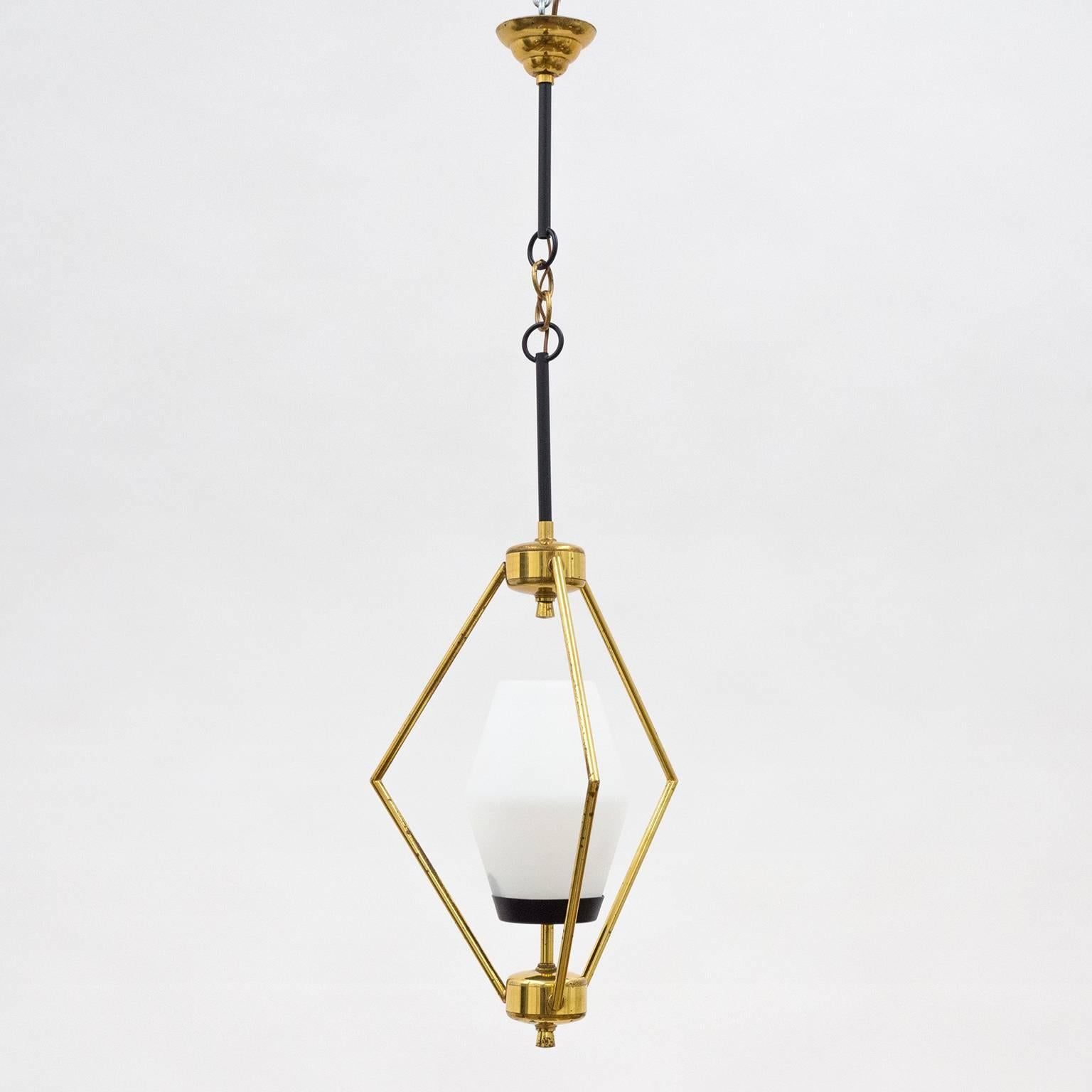 Very unusual brass and glass pendant or lantern from the 1950s. Another fine example of how Italian designers during this period reinterpreted traditional design with a sculptural and Minimalist approach. One original brass and ceramic E14 socket