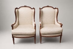 Pair of Louis XVI Style Carved Walnut Wingback Bergere Armchairs, France